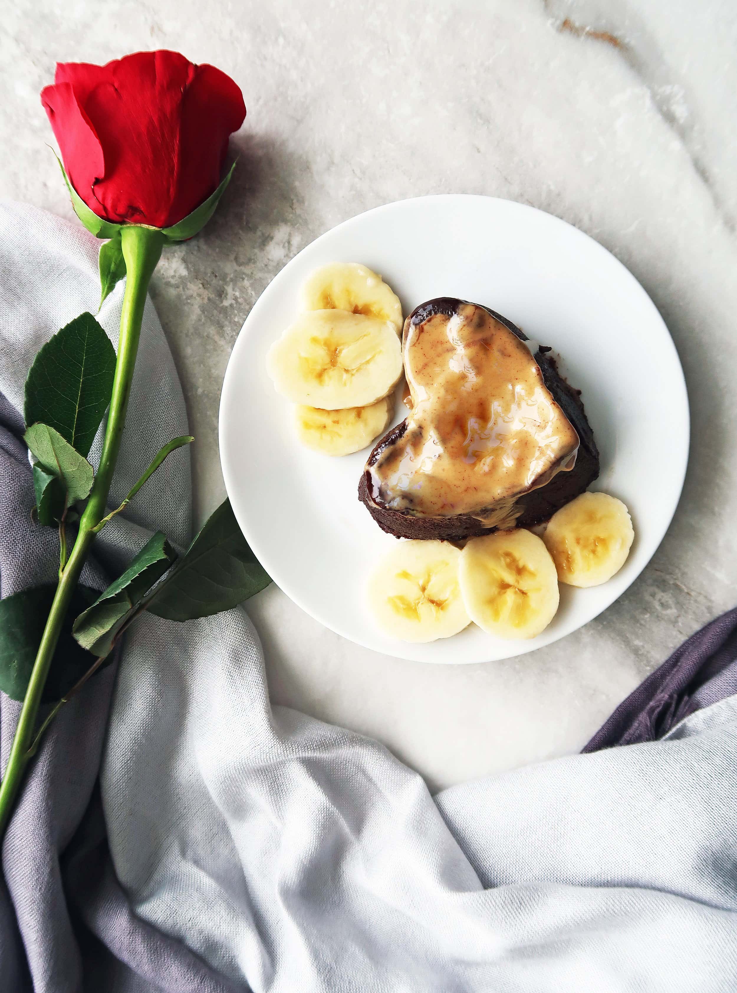 A 3 Minute Peanut Butter Banana Chocolate Mini Cake on a plate with banana slices.