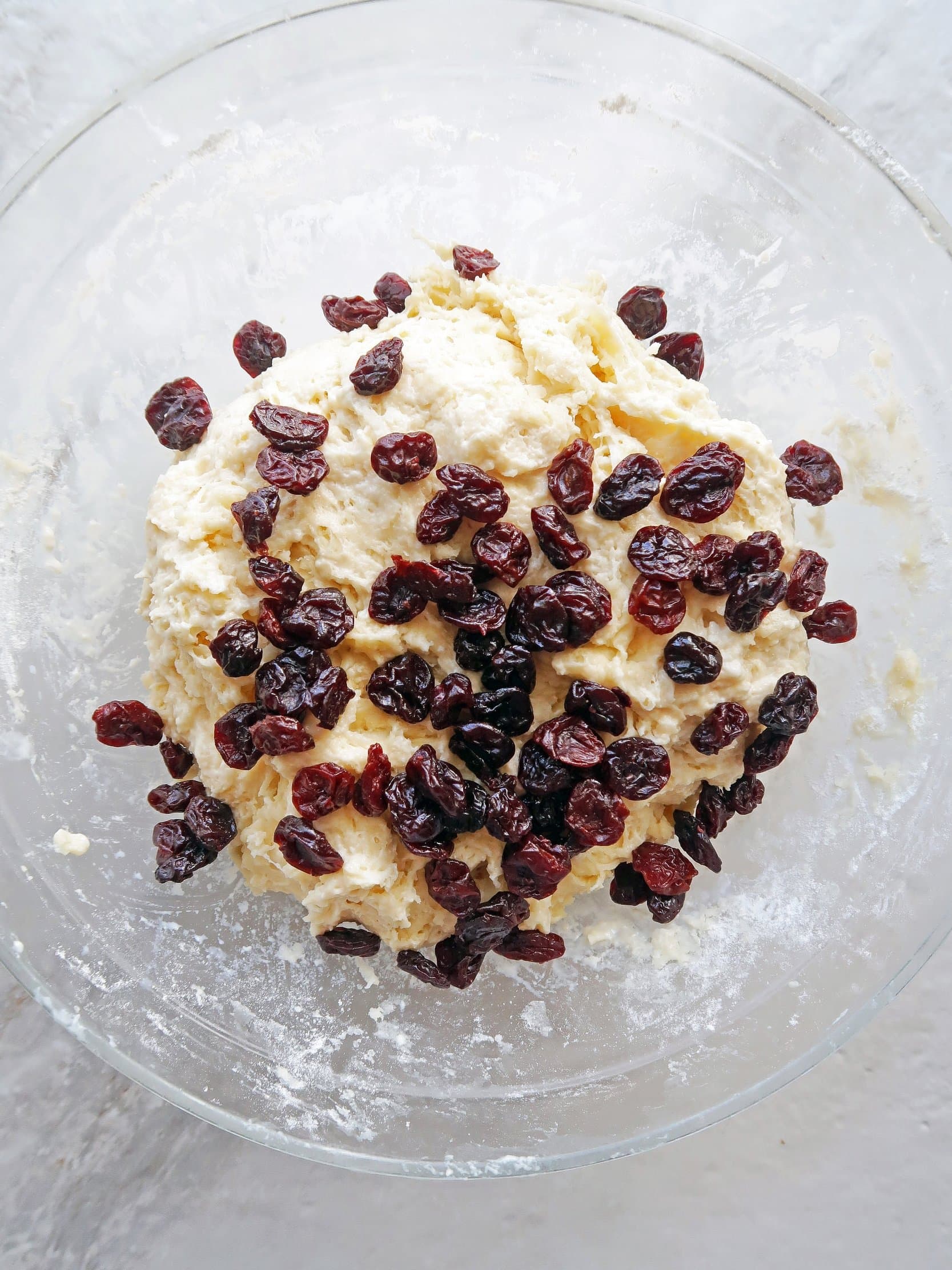 Tea bun dough with dried cherries on top.