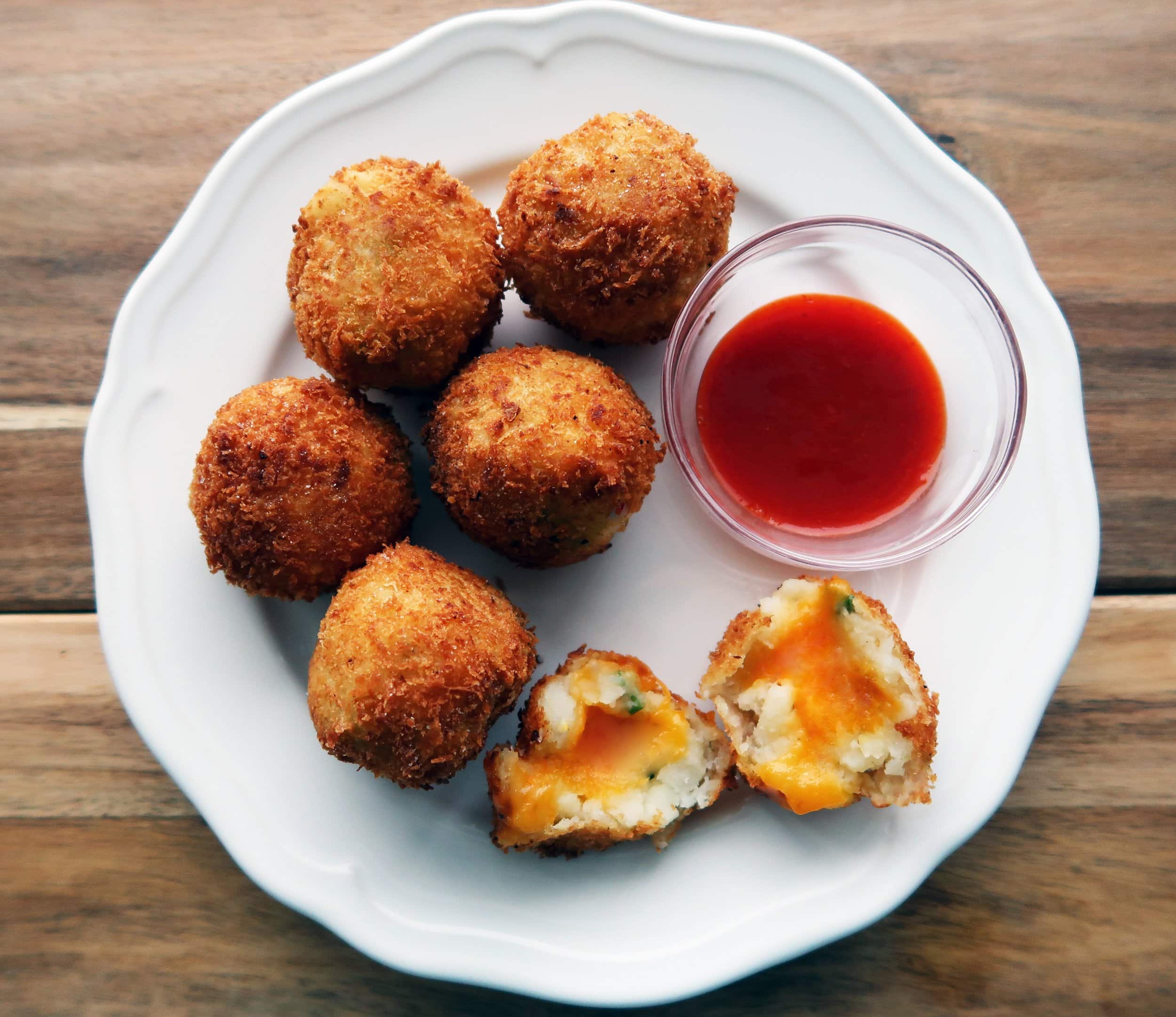 A plate of 5 Ingredient Crispy Mashed Potato Cheese Balls.