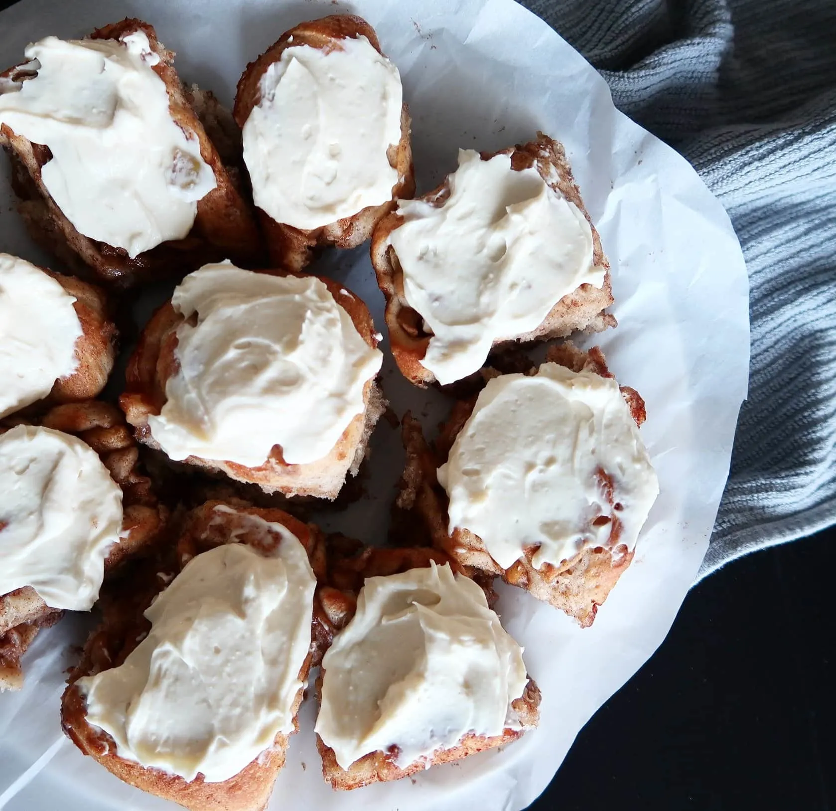 A plate of Apple Cinnamon Rolls with Maple Cream Cheese Frosting.
