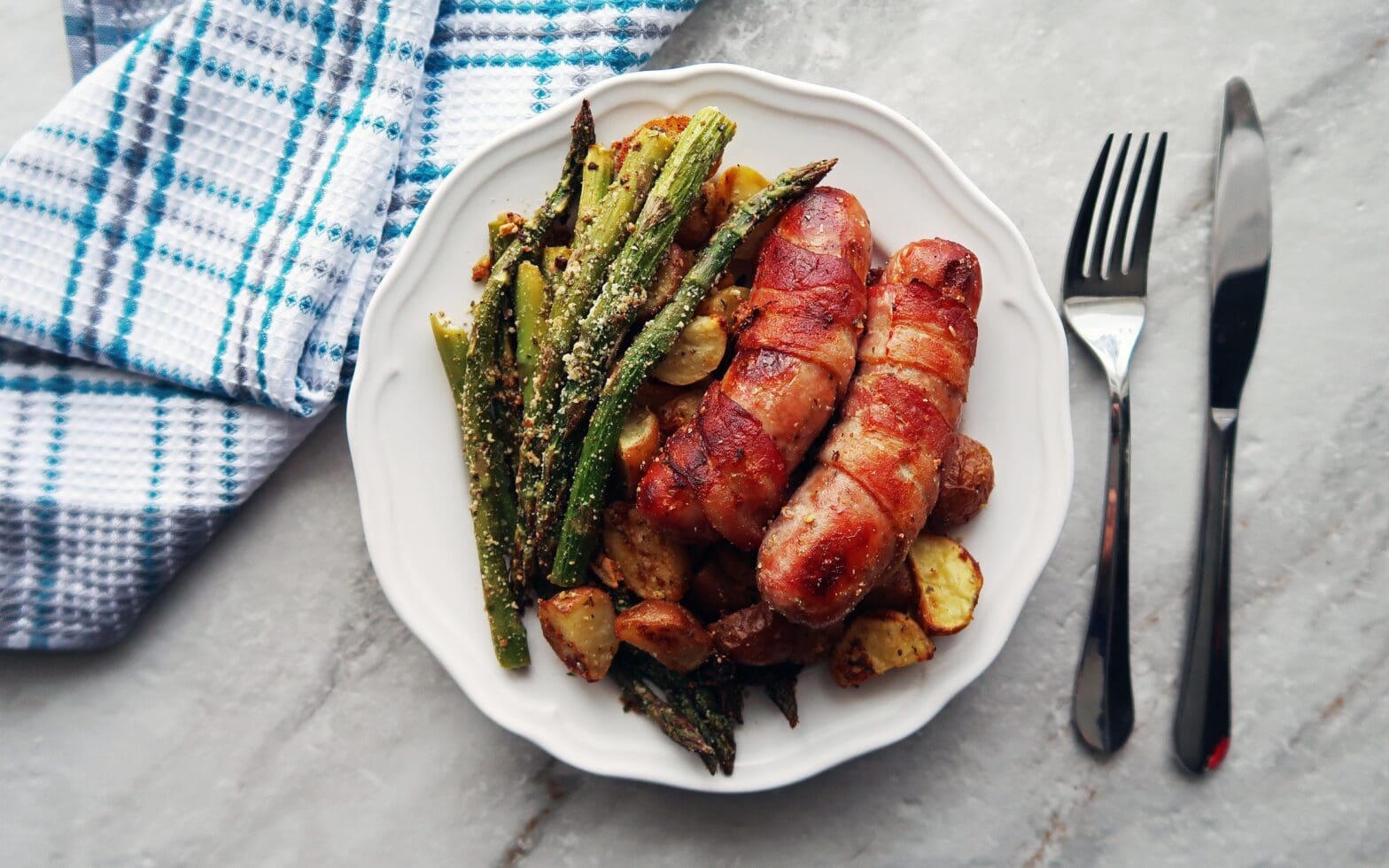 BaconWrapped Sausages with Garlic Parmesan Asparagus and Potatoes