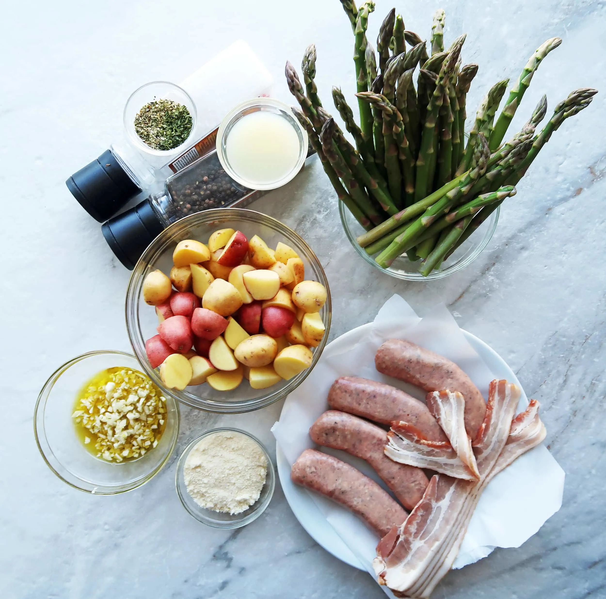 Sausages, potatoes, asparagus, parmesan, garlic, and olive oil.