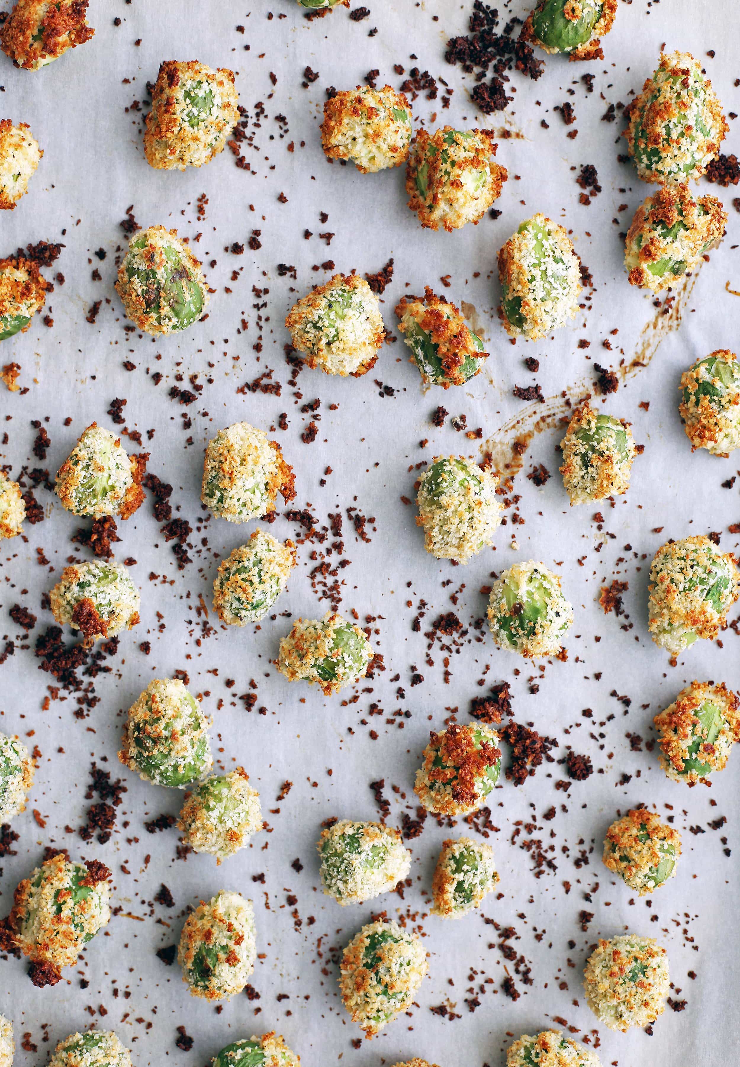 Baked parmesan Panko Brussels sprouts on a parchment paper lined baking sheet.
