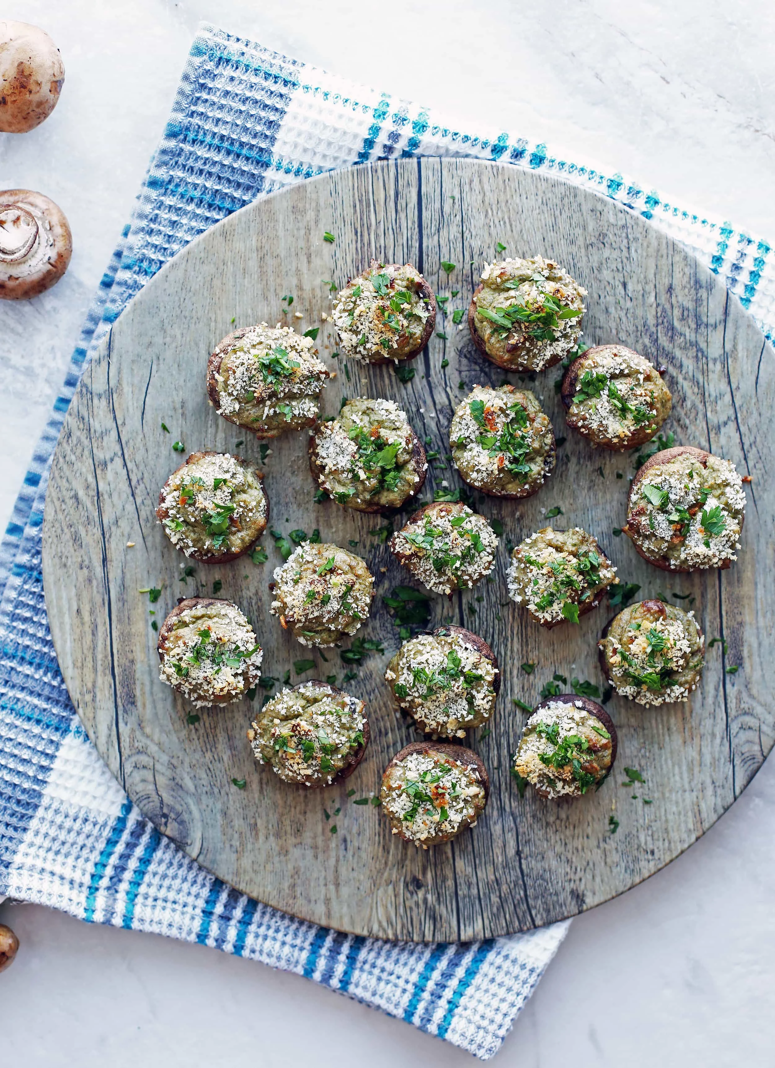 Overhead view of Baked Cheese Stuffed Mushrooms with breadcrumb and parsley topping.