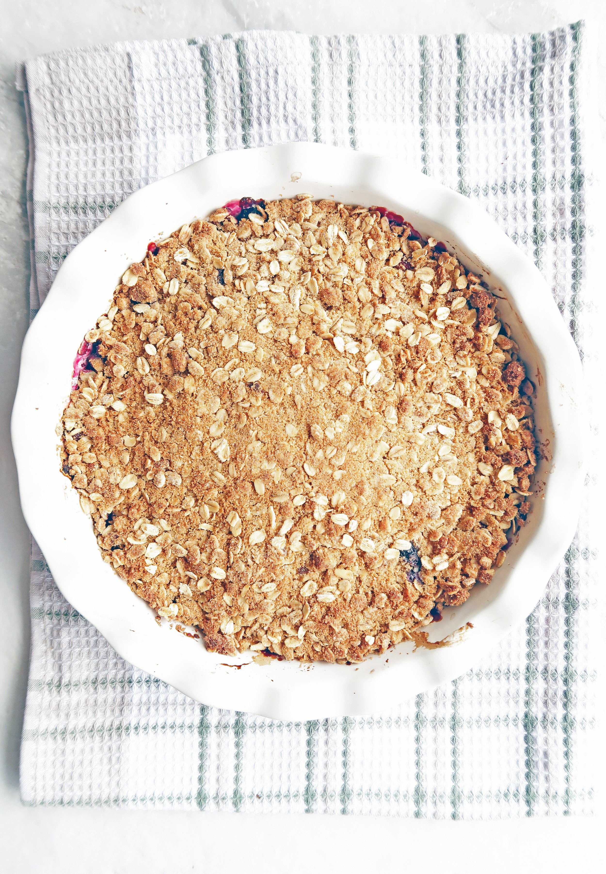 Baked oat crisp topping on top of cherries and blueberries.