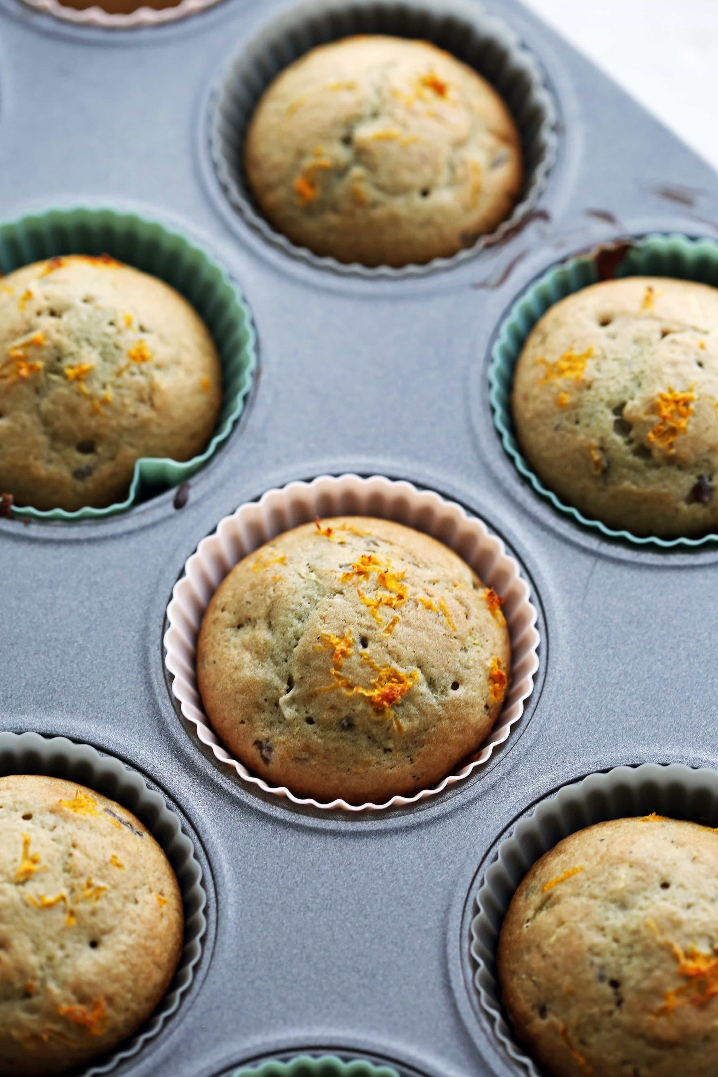 Freshly baked cranberry orange muffins in a muffin pan.