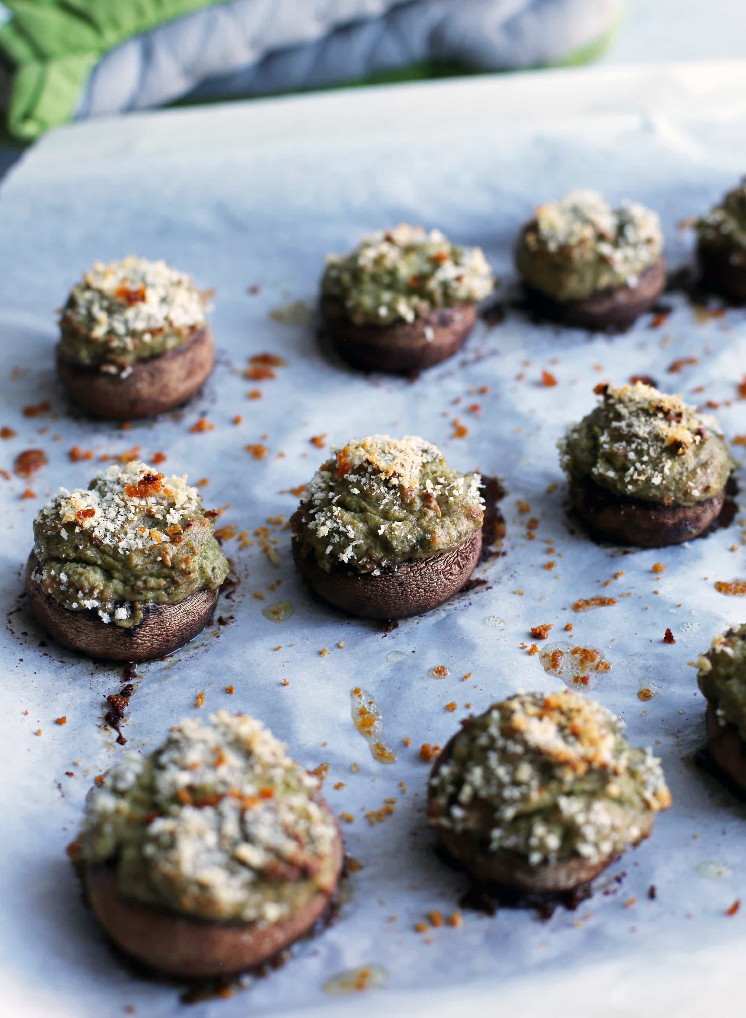 Baked cheese mushrooms with panko breadcrumbs on a baking sheet.