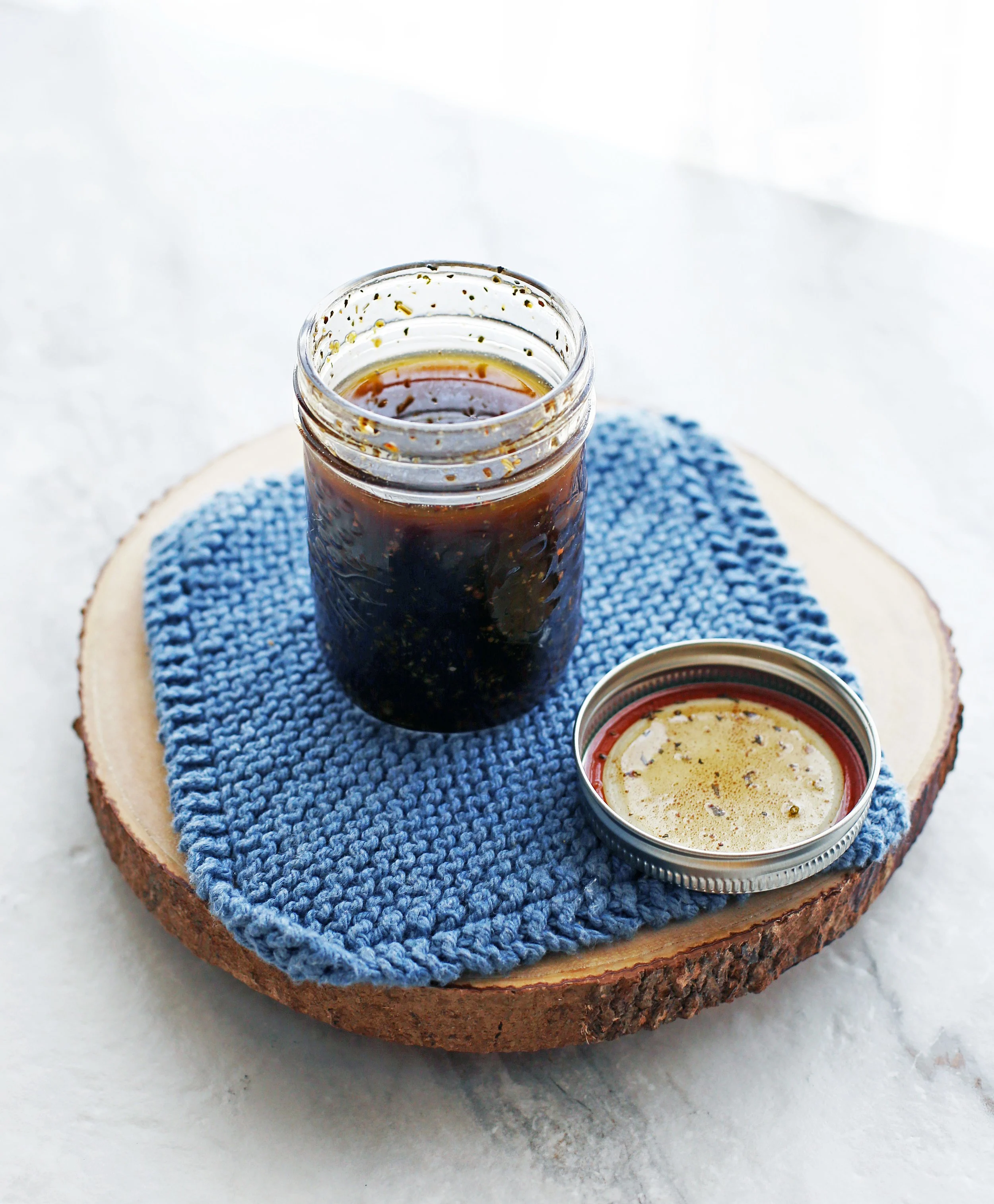 A mason jar containing homemade Dijon-balsamic vinaigrette.