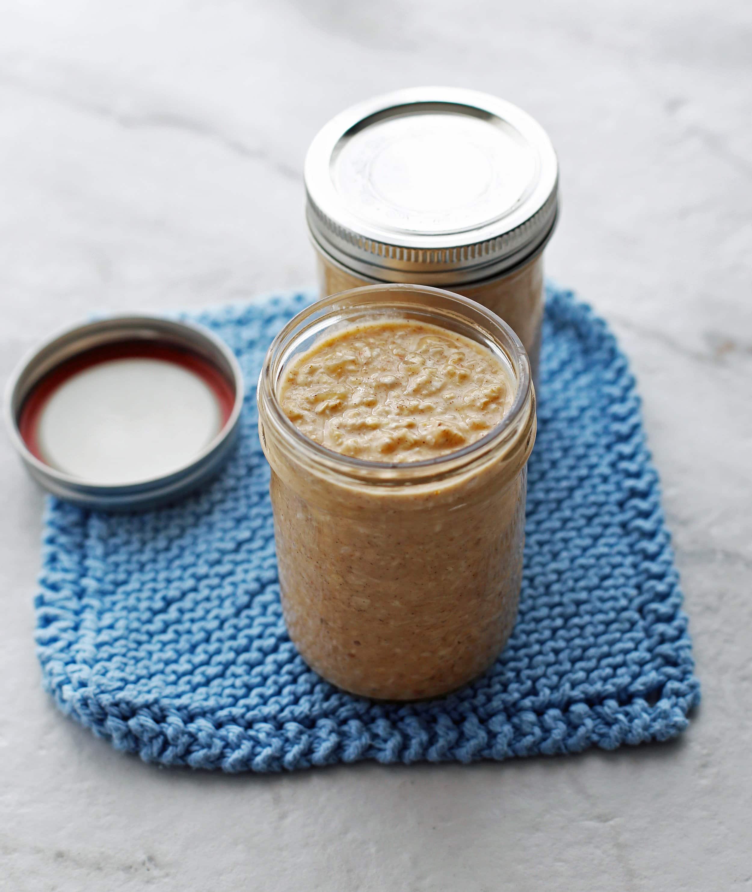 Banana Coconut Cream Pie Overnight Oats in two mason jars.