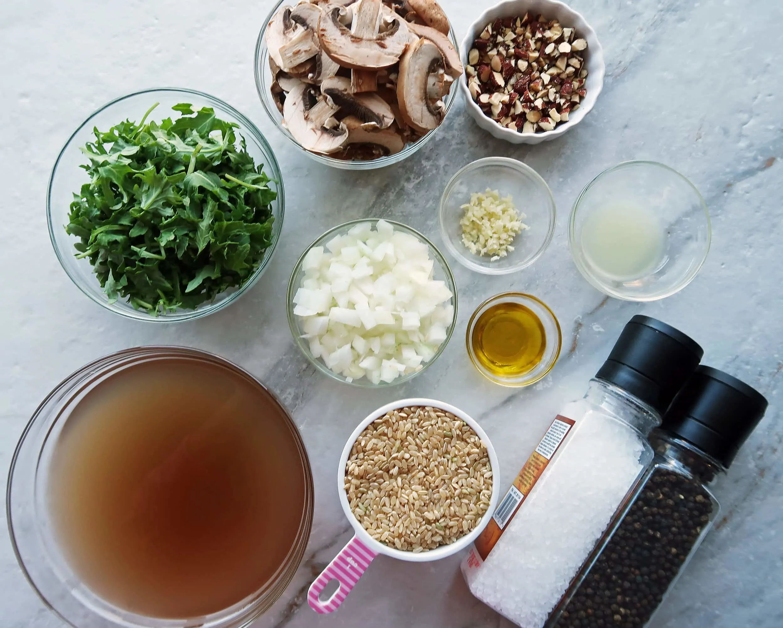 Brown rice, broth, onions, garlic, kale, mushrooms, and almonds.