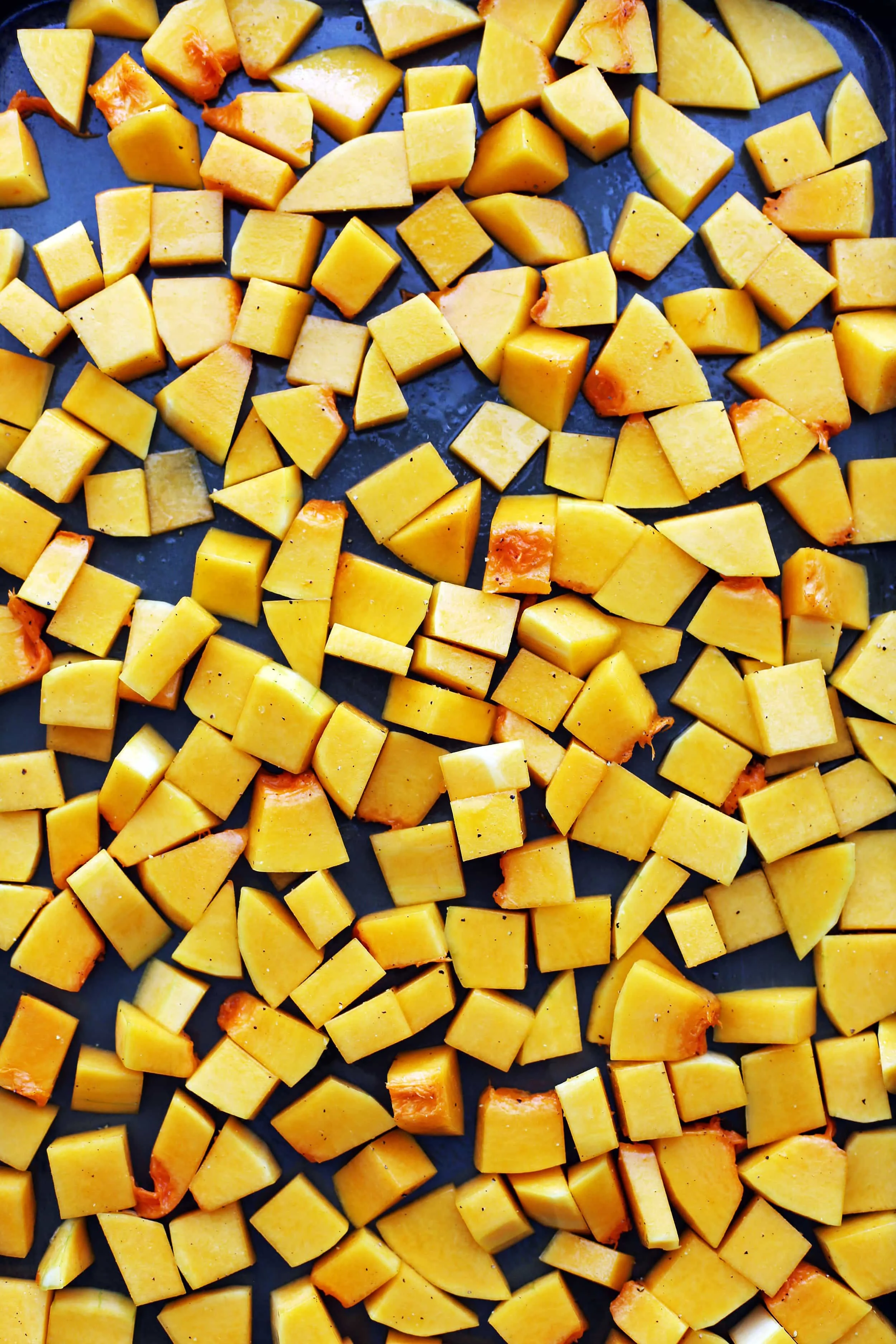 Chopped butternut squash on a baking sheet.