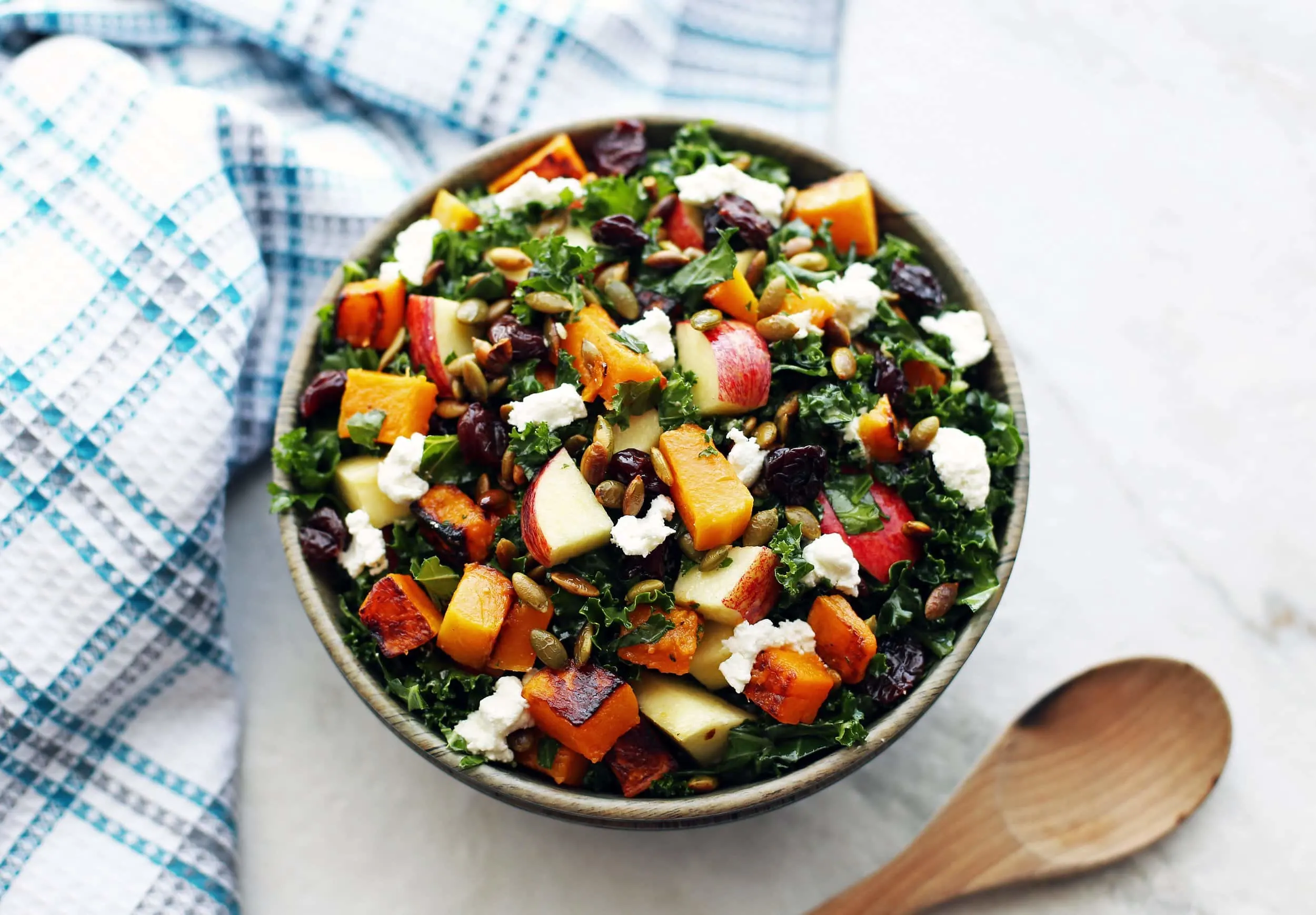 Overhead angled view of a bowl of Roasted Butternut Squash and Apple Kale Salad with Lemon Vinaigrette