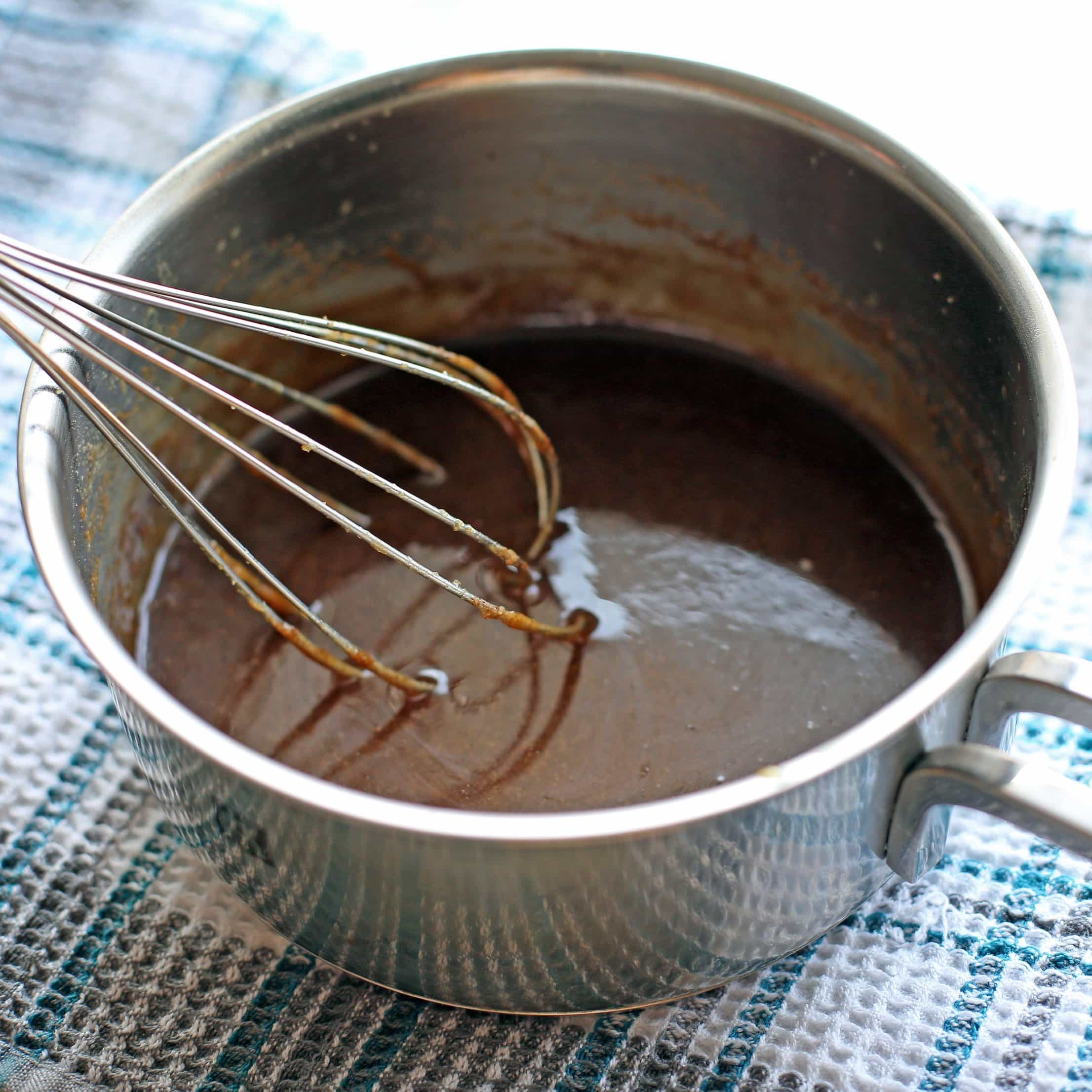 Homemade butterscotch sauce in a small saucepan.