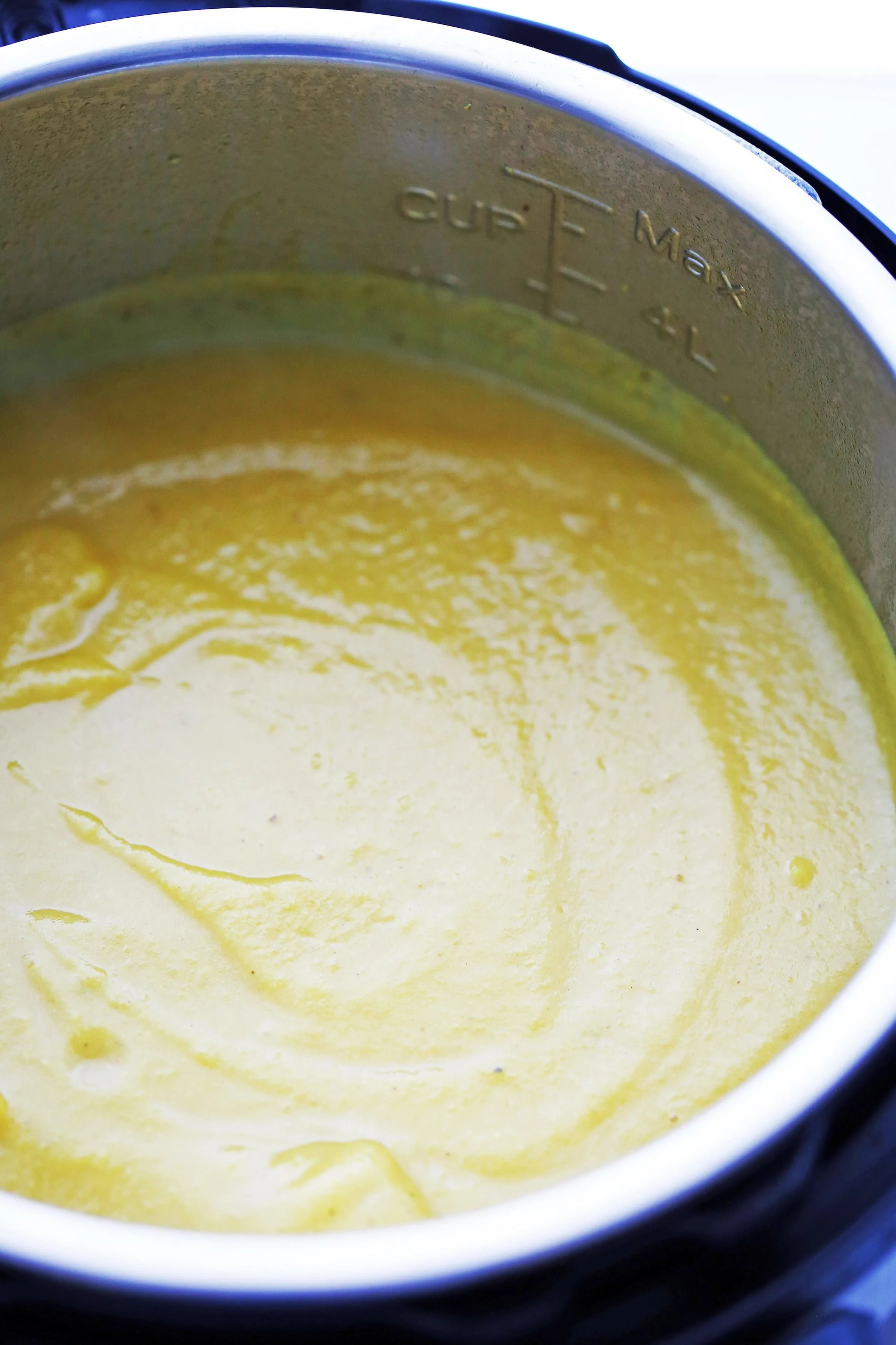 Turmeric cauliflower potato soup that has been blended until creamy in the Instant Pot.