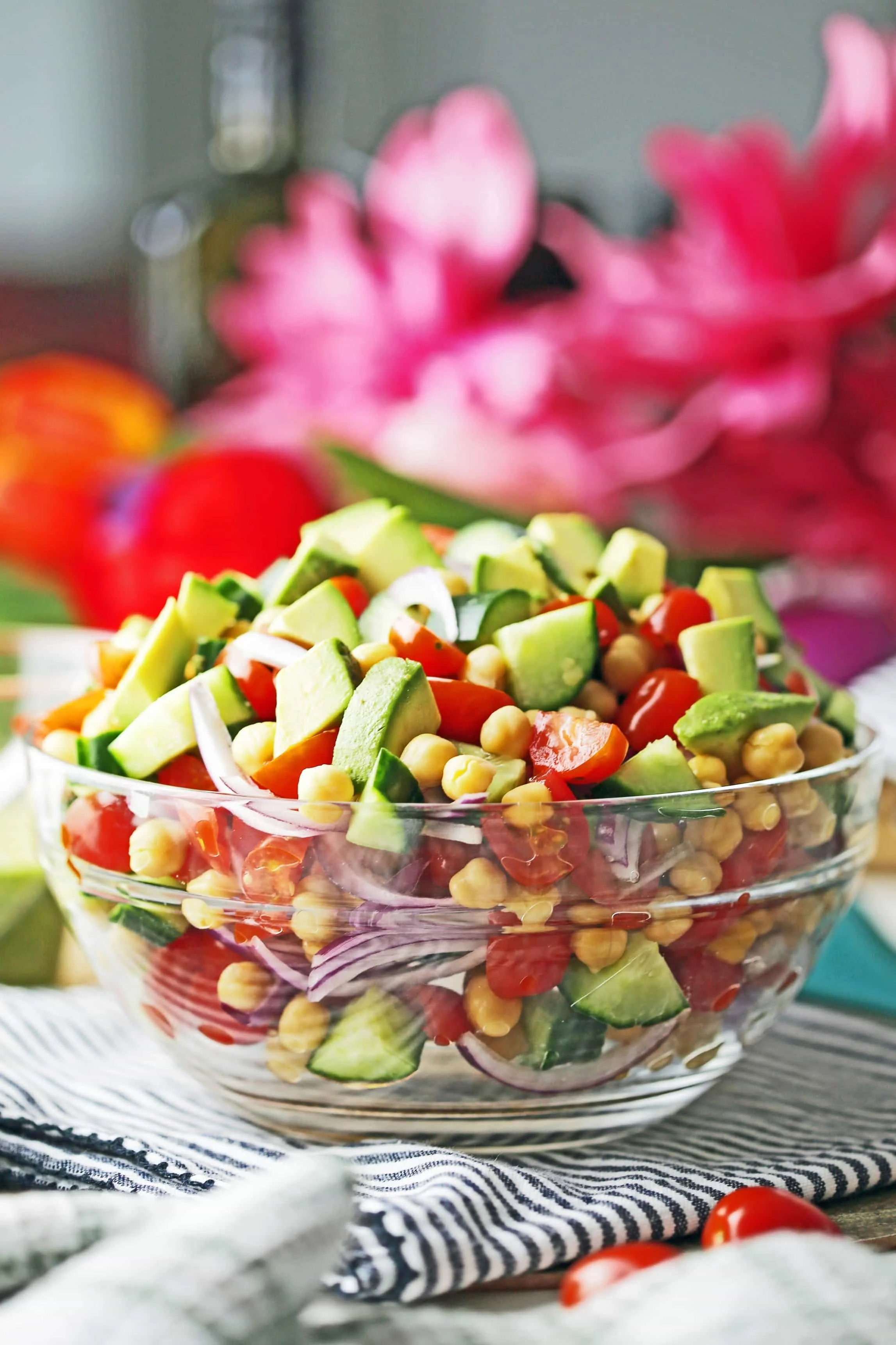 A side view of Chickpea Cucumber Avocado Salad in a large glass bowl.