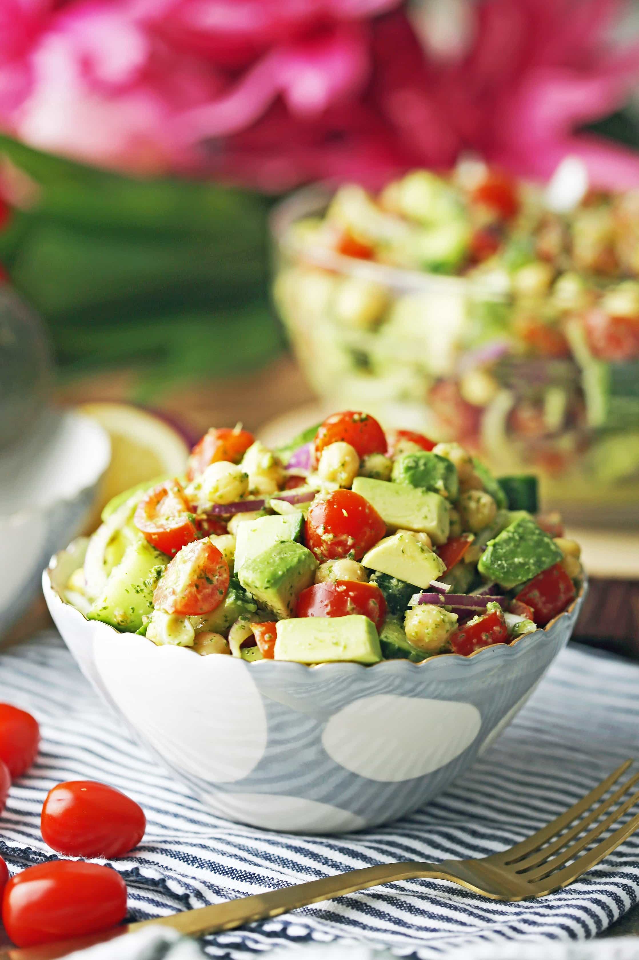 Chickpea Cucumber Avocado Salad with Parsley Dressing in a blue and white bowl with fork on the side.