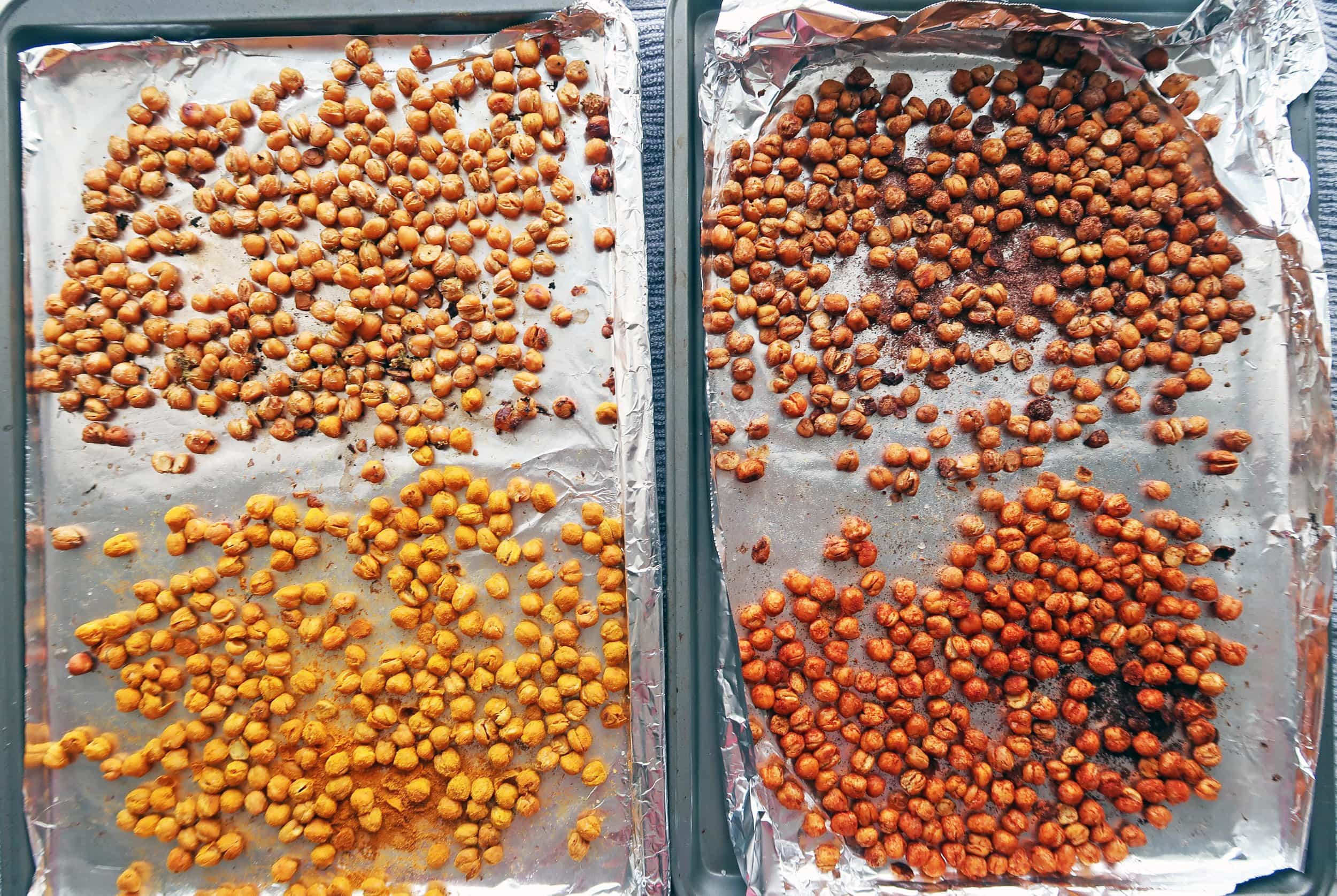 Two baking sheets featuring four flavours of roasted chickpeas.