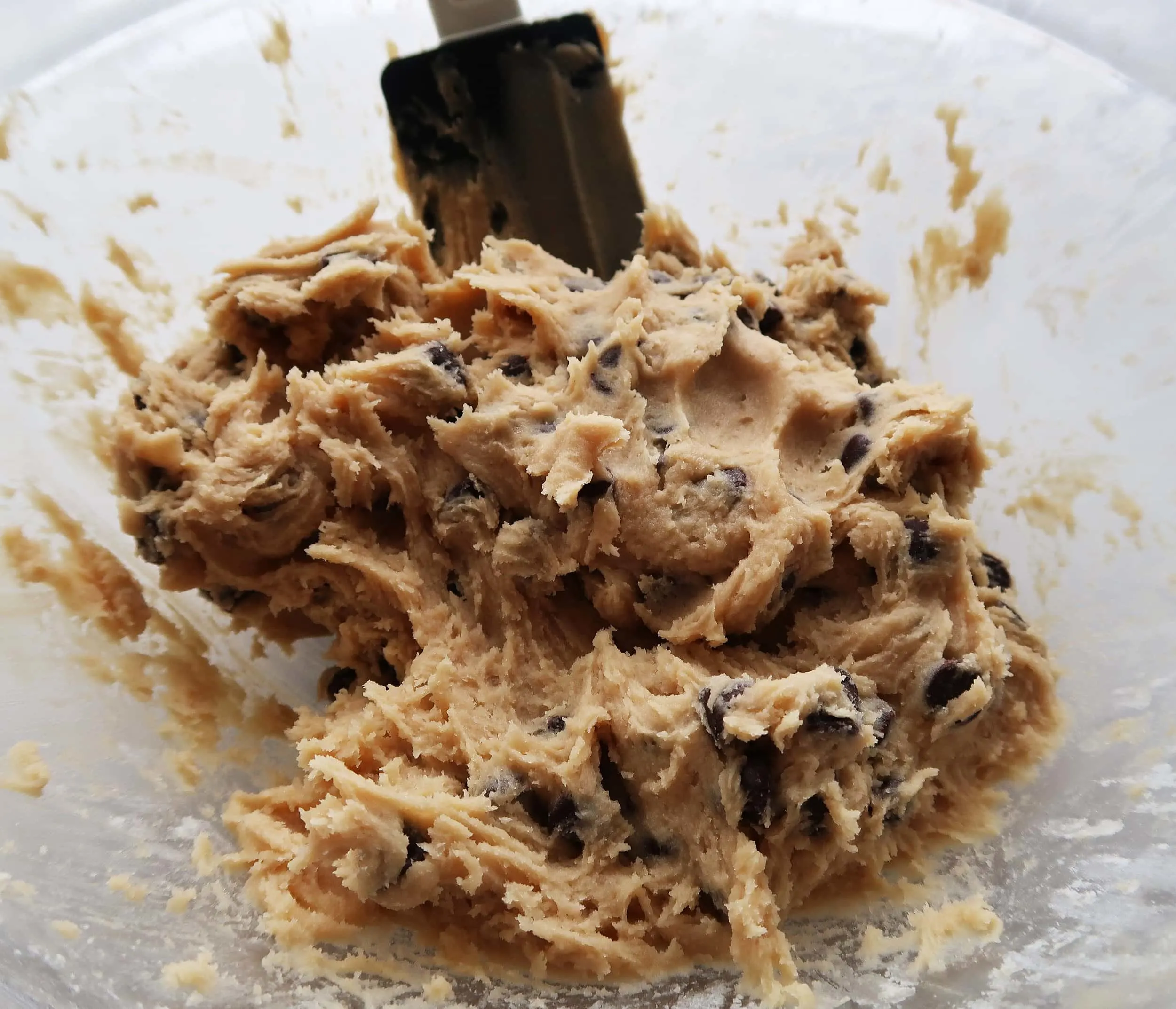 Chocolate chip cookie dough in a bowl.