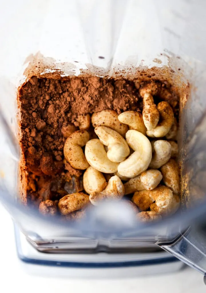 Overhead view of vegan chocolate dip ingredients in a blender container.