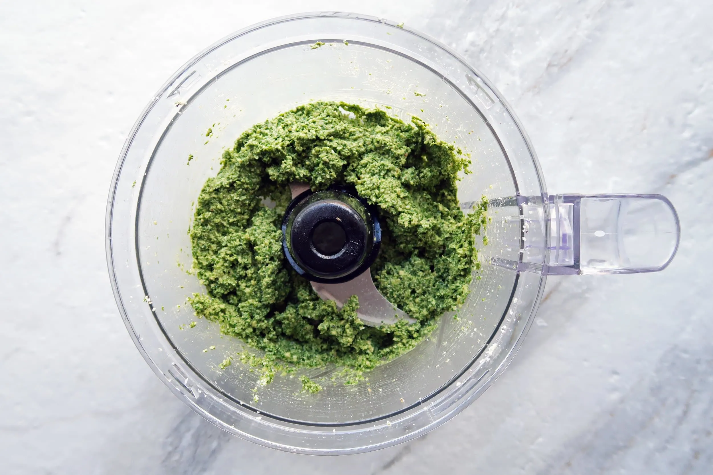 A chunky pesto in a food processor.