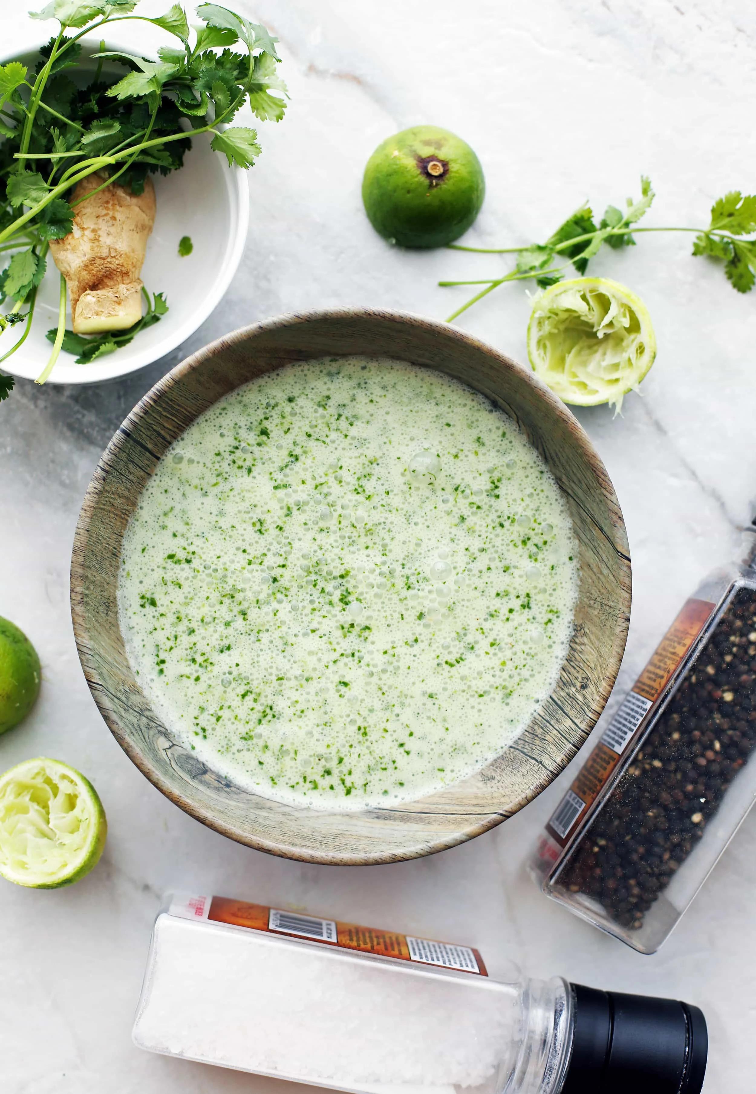 Cilantro lime coconut sauce in a wooden bowl.