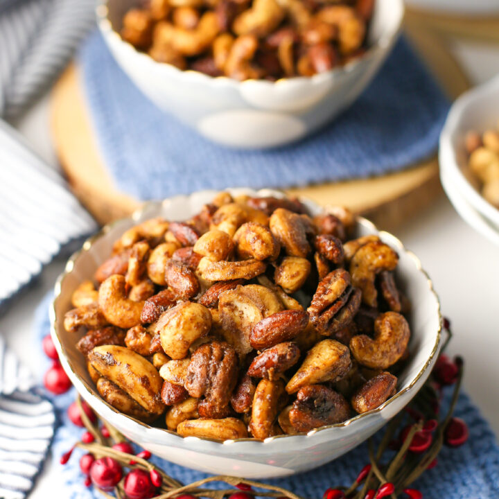 Two bowls containing baked cinnamon sugar mixed nuts.