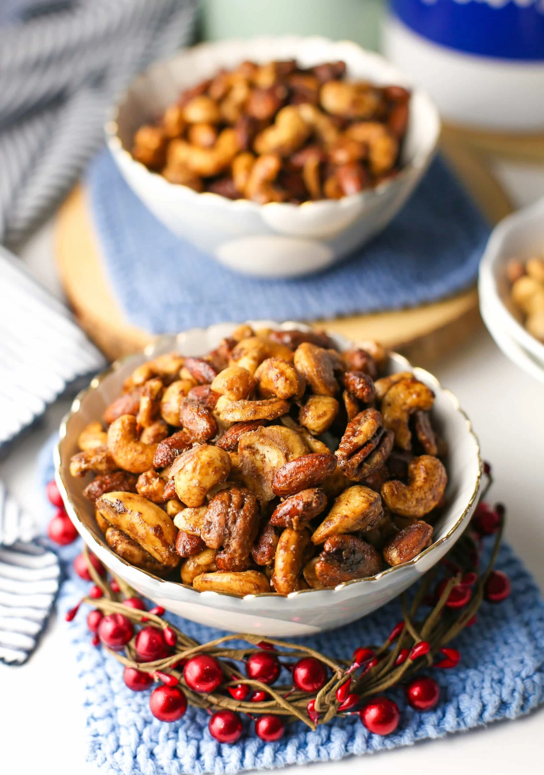 Two bowls containing baked cinnamon sugar mixed nuts.