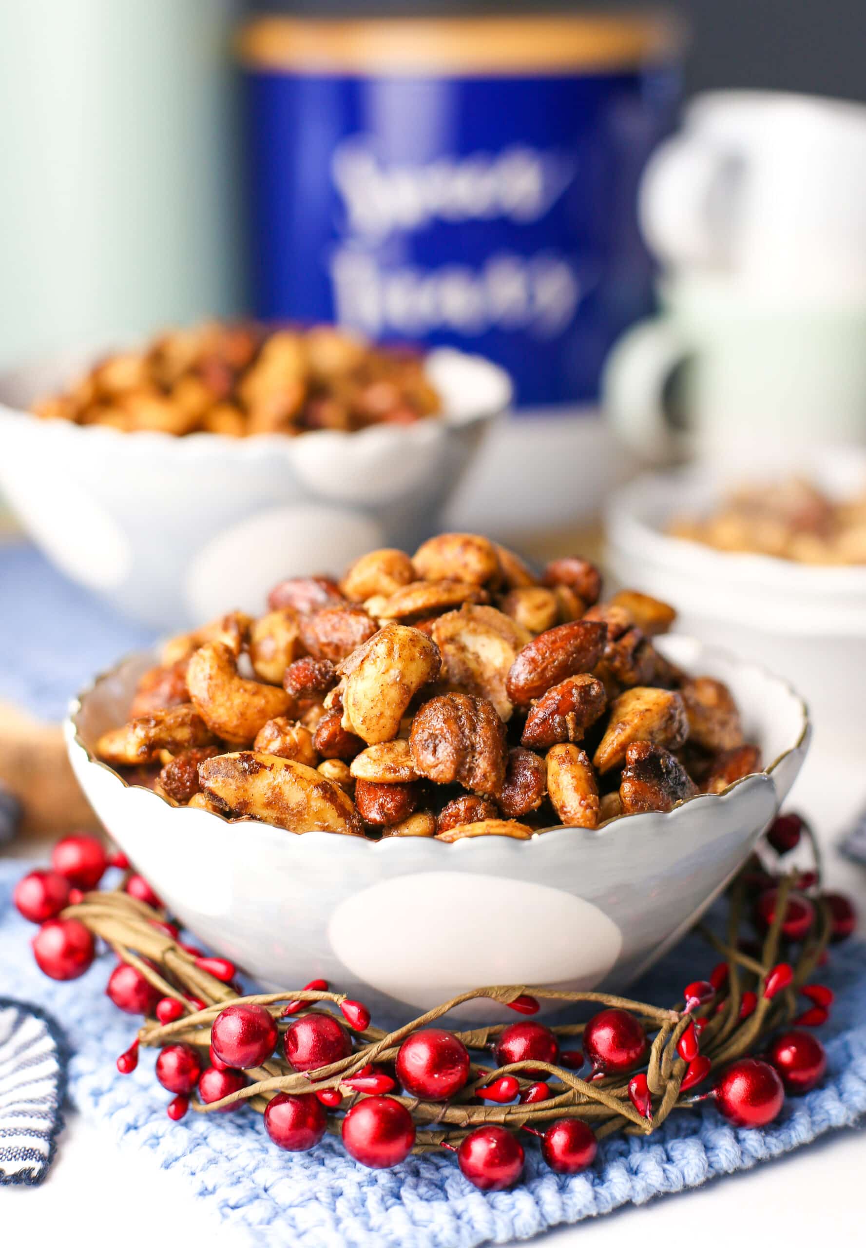 A side view of a blue and white bowl filled with crunchy cinnamon sugar nuts.