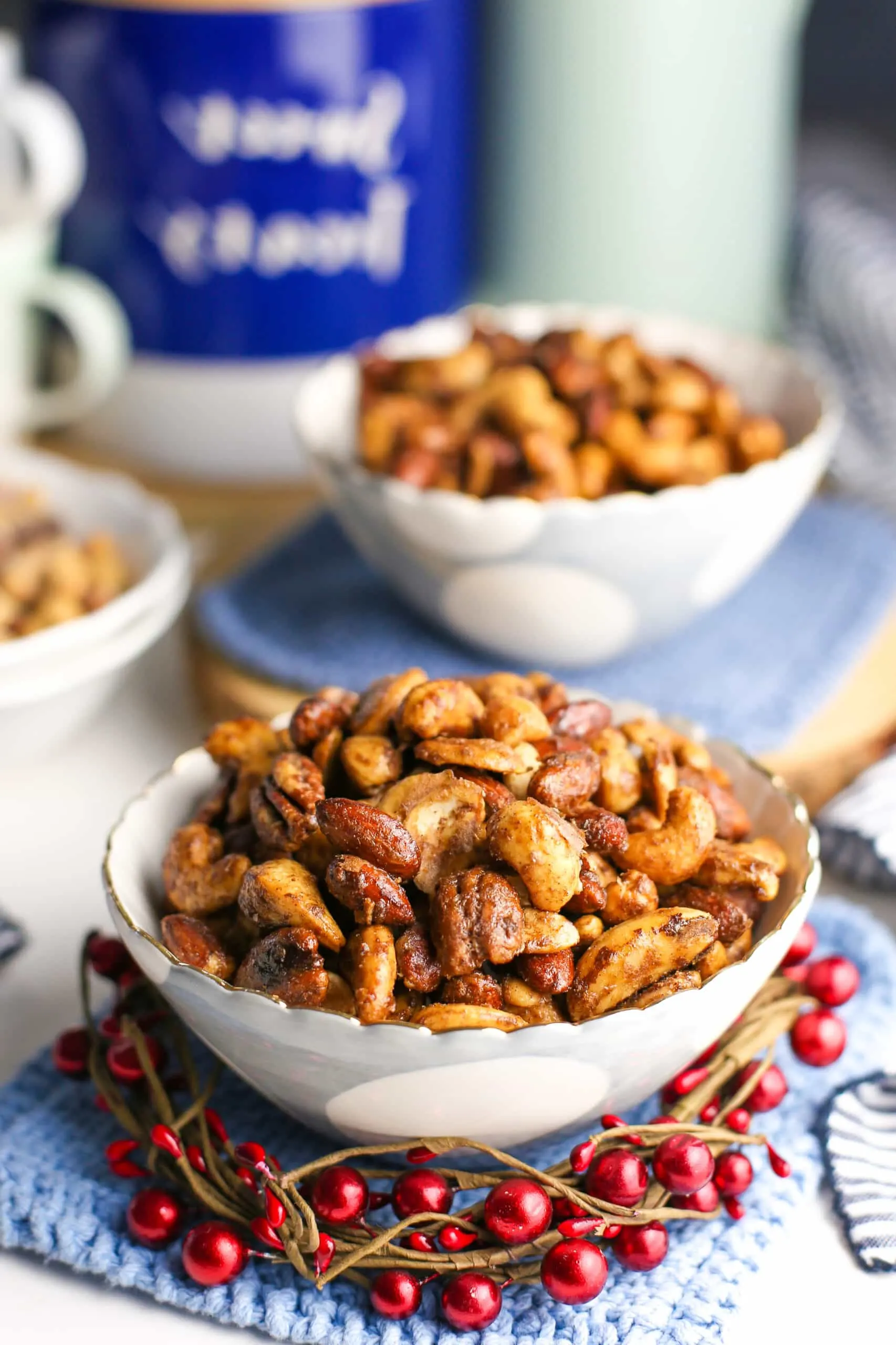 Cinnamon sugar mixed nuts in two white and blue bowls.