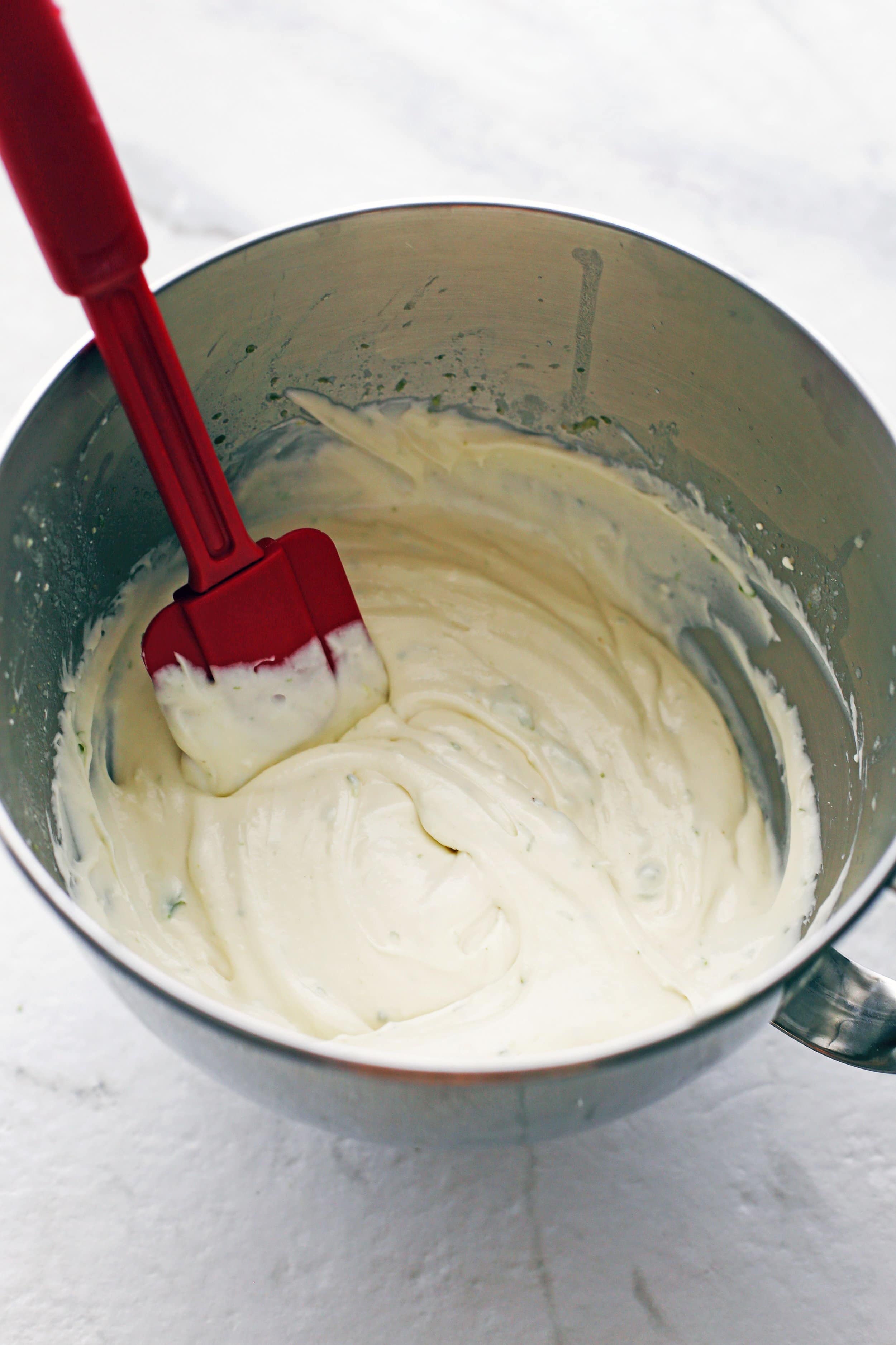 In a large mixing bowl, mascarpone, cream cheese, lime juice and zest, vanilla extract, and salt is combined together to form a creamy, thick filling