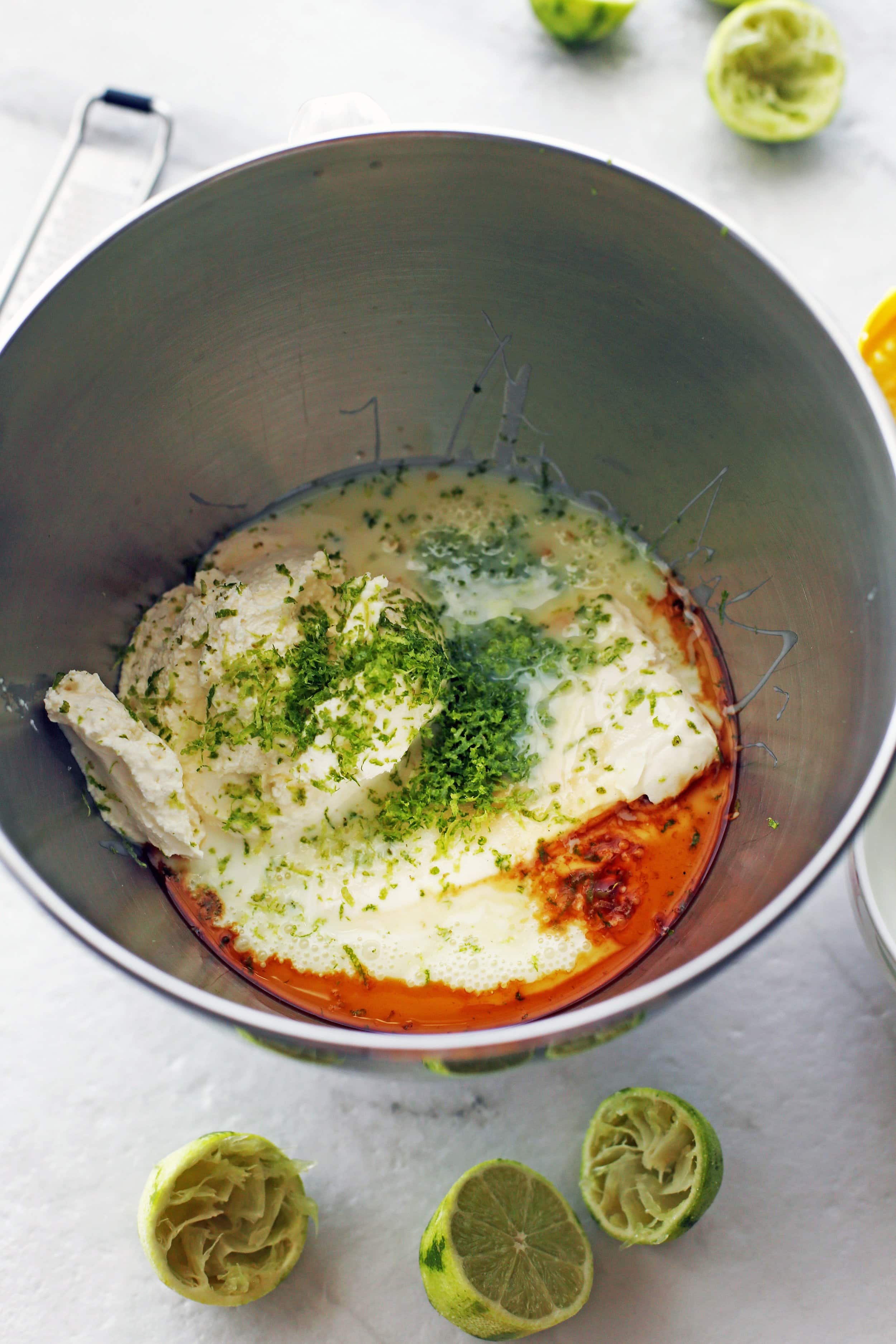 Mascarpone cheese, cream cheese, condensed milk, lime juice and zest, vanilla extract, and salt in a large mixing bowl.