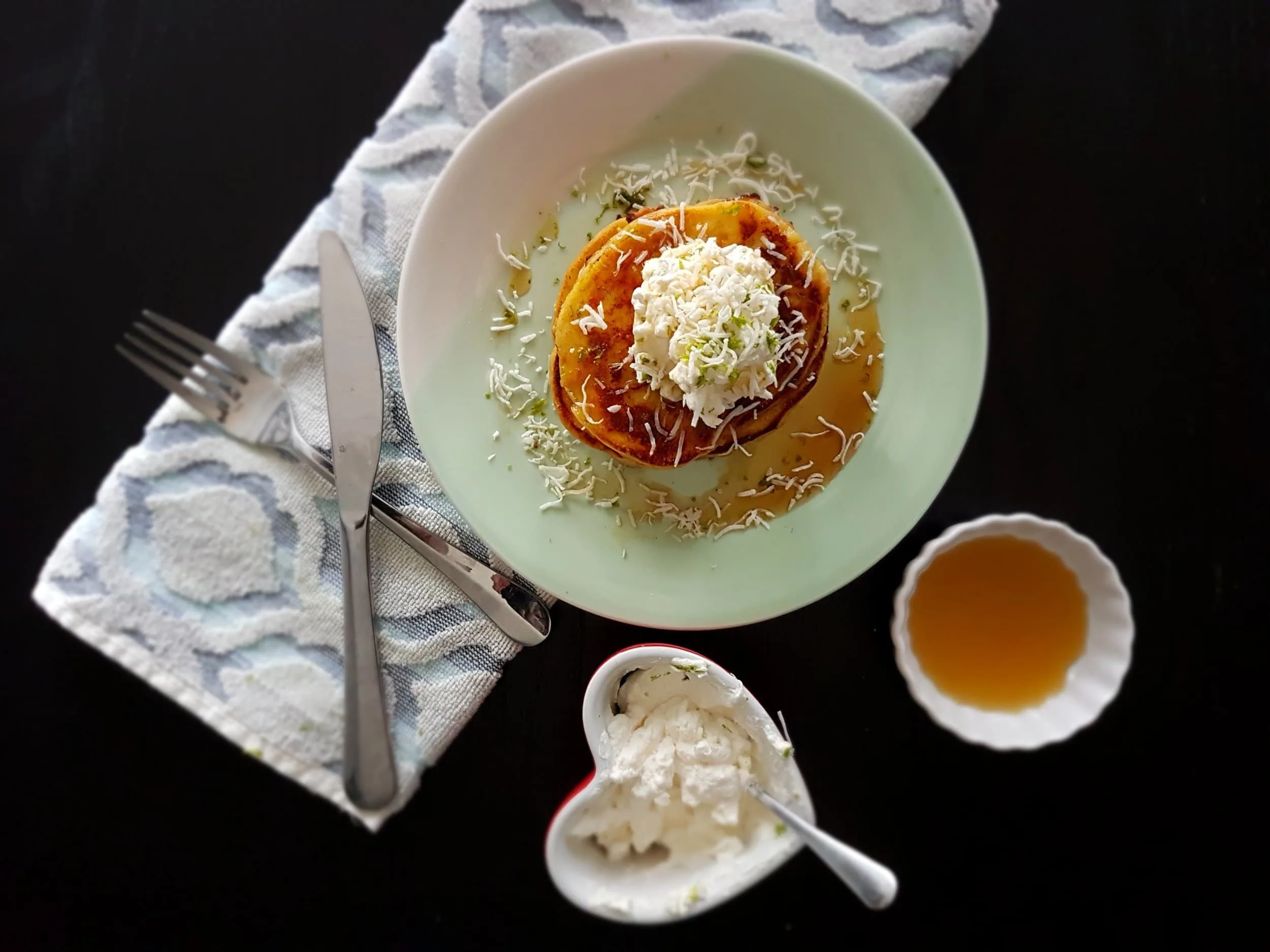 Coconut Lime Ricotta Pancakes with extra whipped cream and maple syrup on the side.