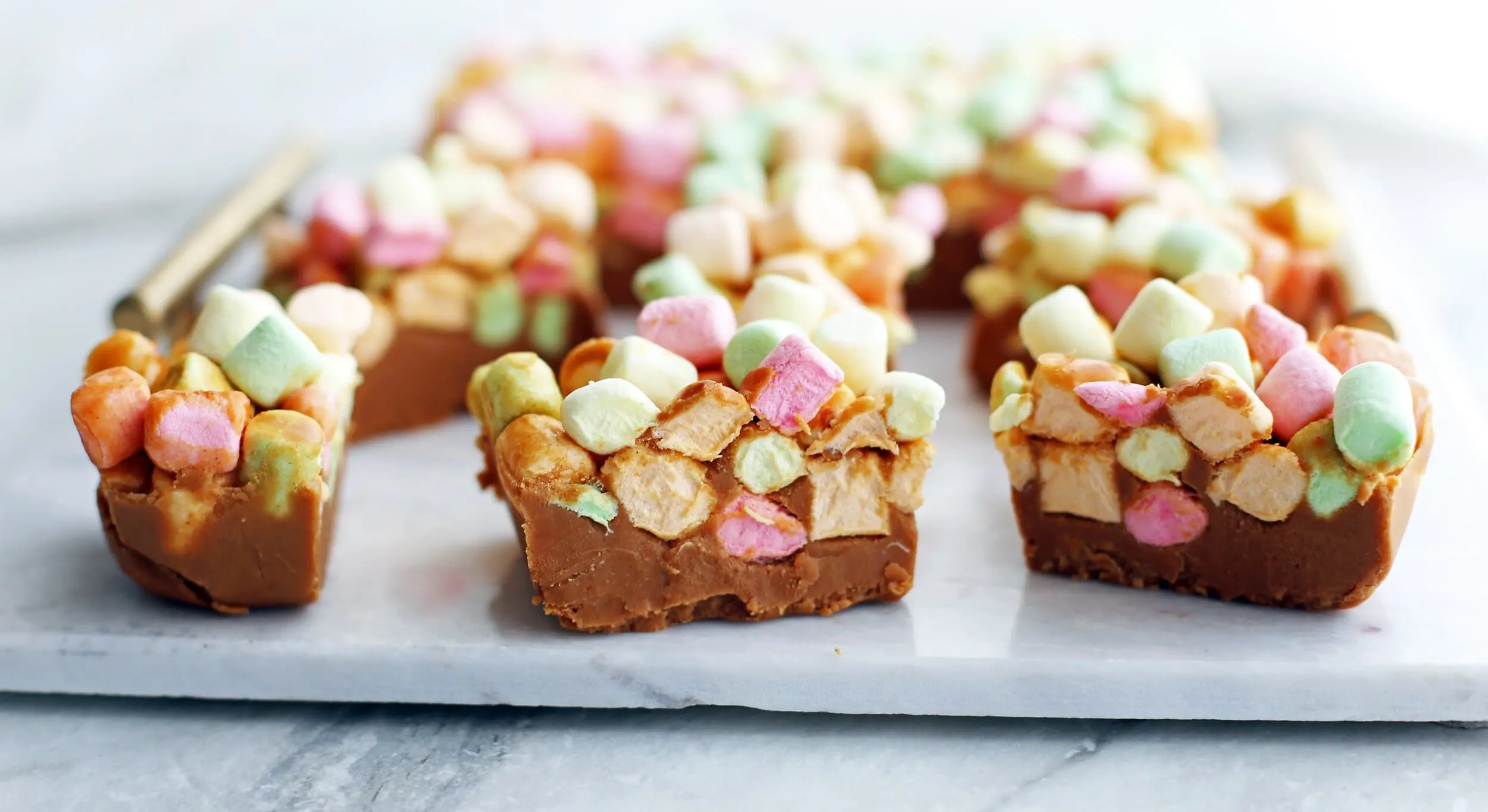 Side view of peanut butter butterscotch marshmallow bars with two distinct layers.