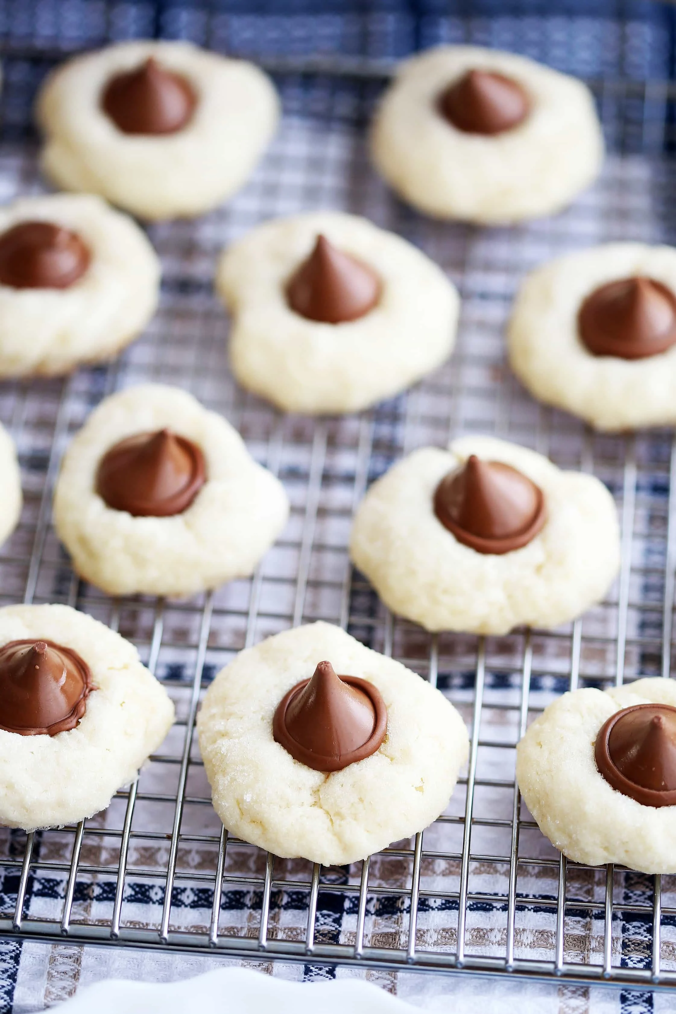An up-close view of Cream Cheese Kiss Cookies on a metal cooling rack.