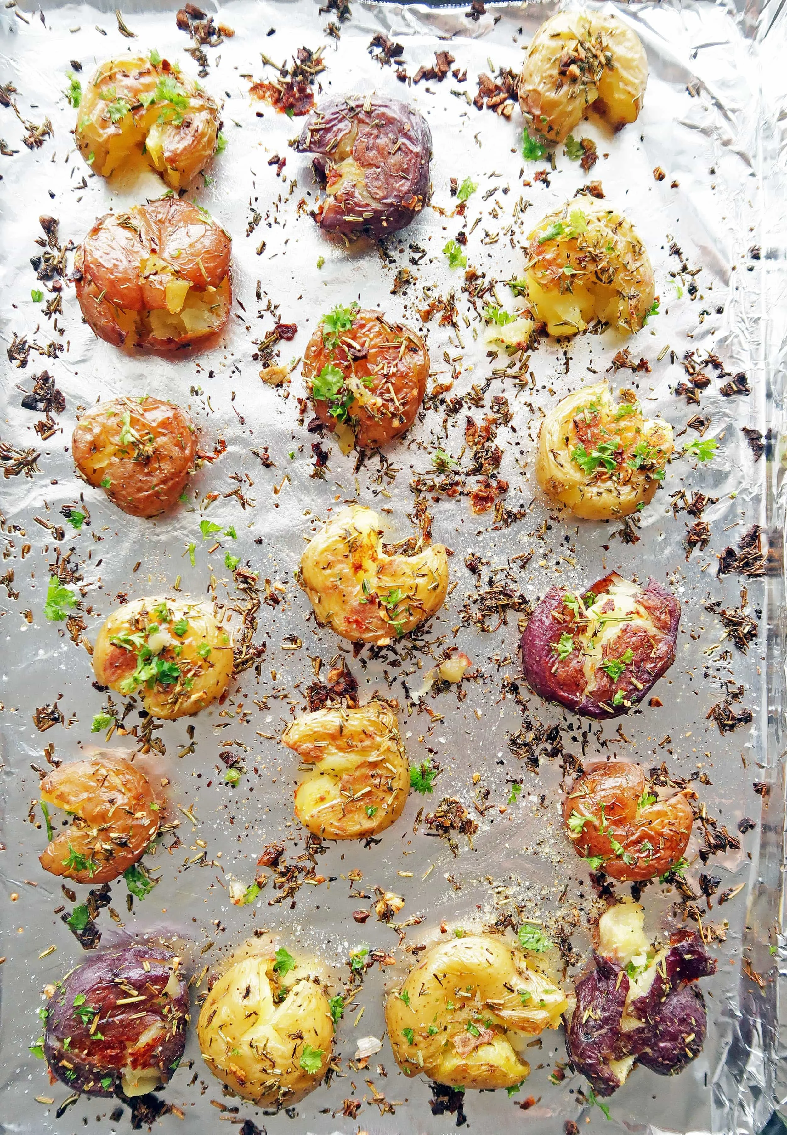 Vegan and gluten-free Crispy Garlic Smashed Baby Potatoes on a baking sheet.
