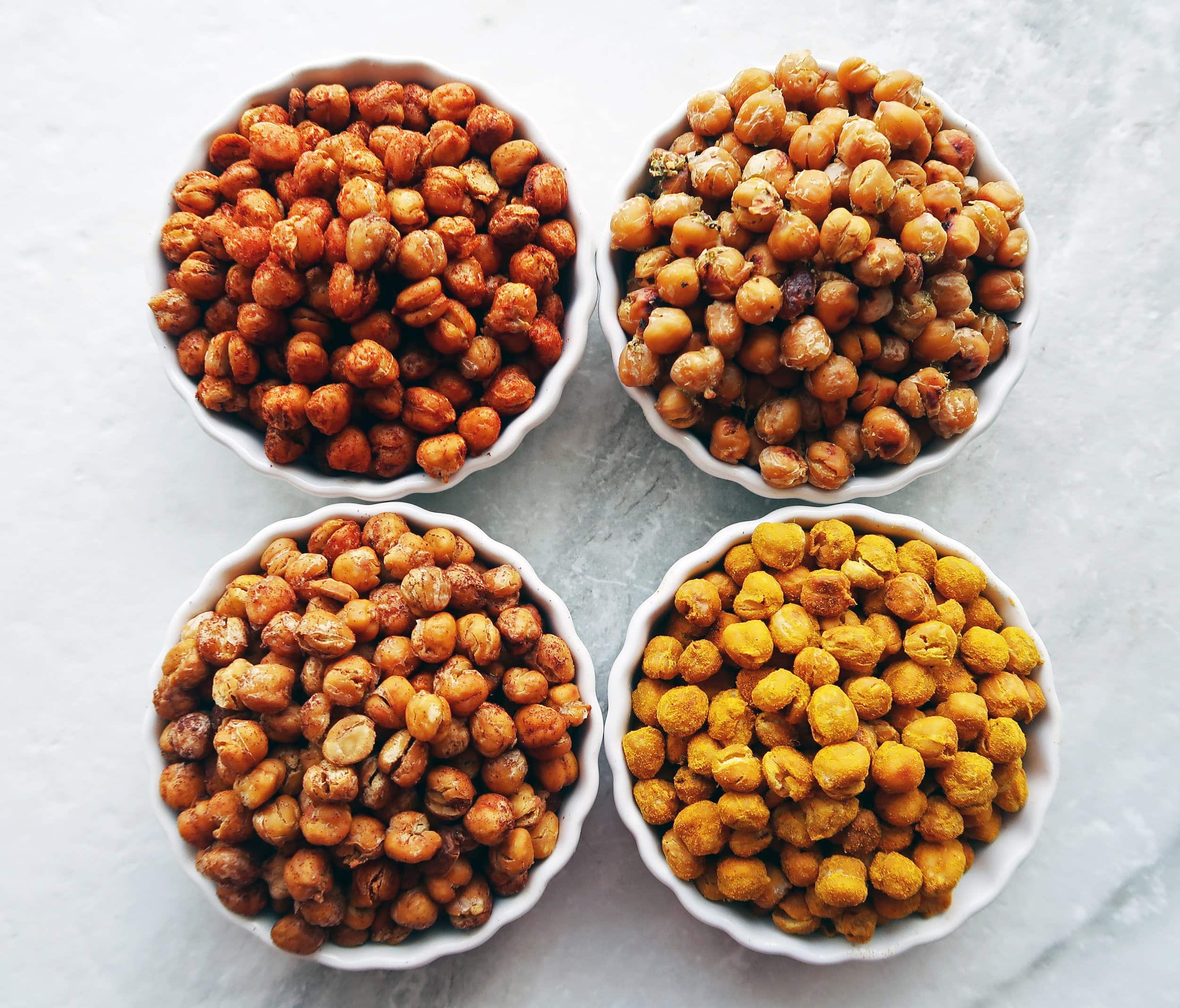 Four bowls of crunchy, oven-roasted chickpeas.