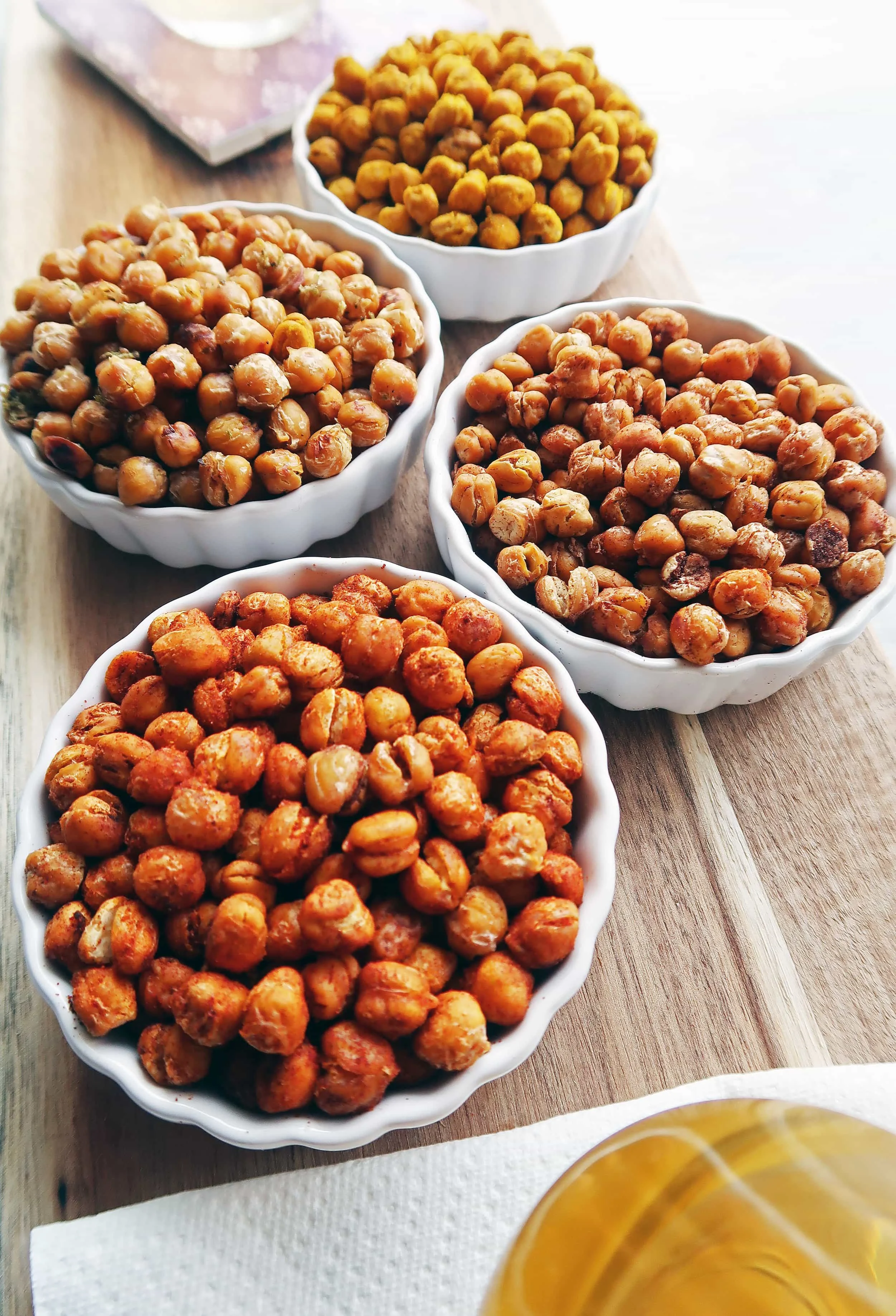 Crunchy Oven Roasted Chickpeas 4 Ways, each in a separate bowl.