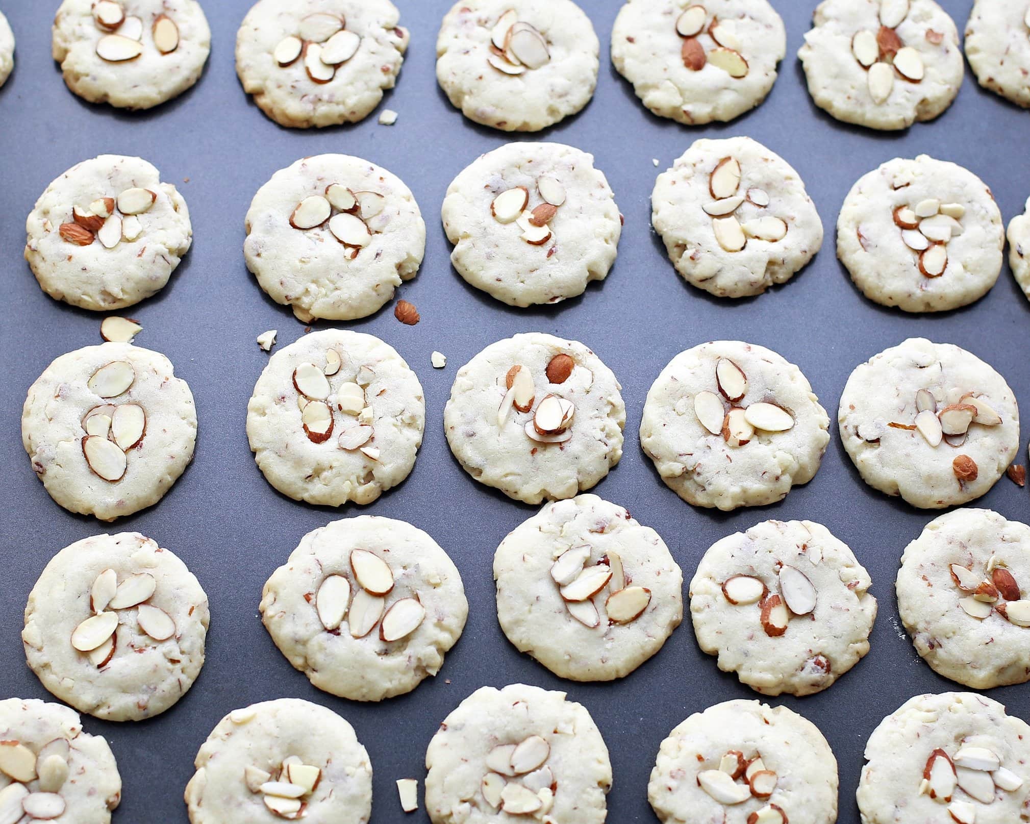 Baked almond cookies on a baking sheet.
