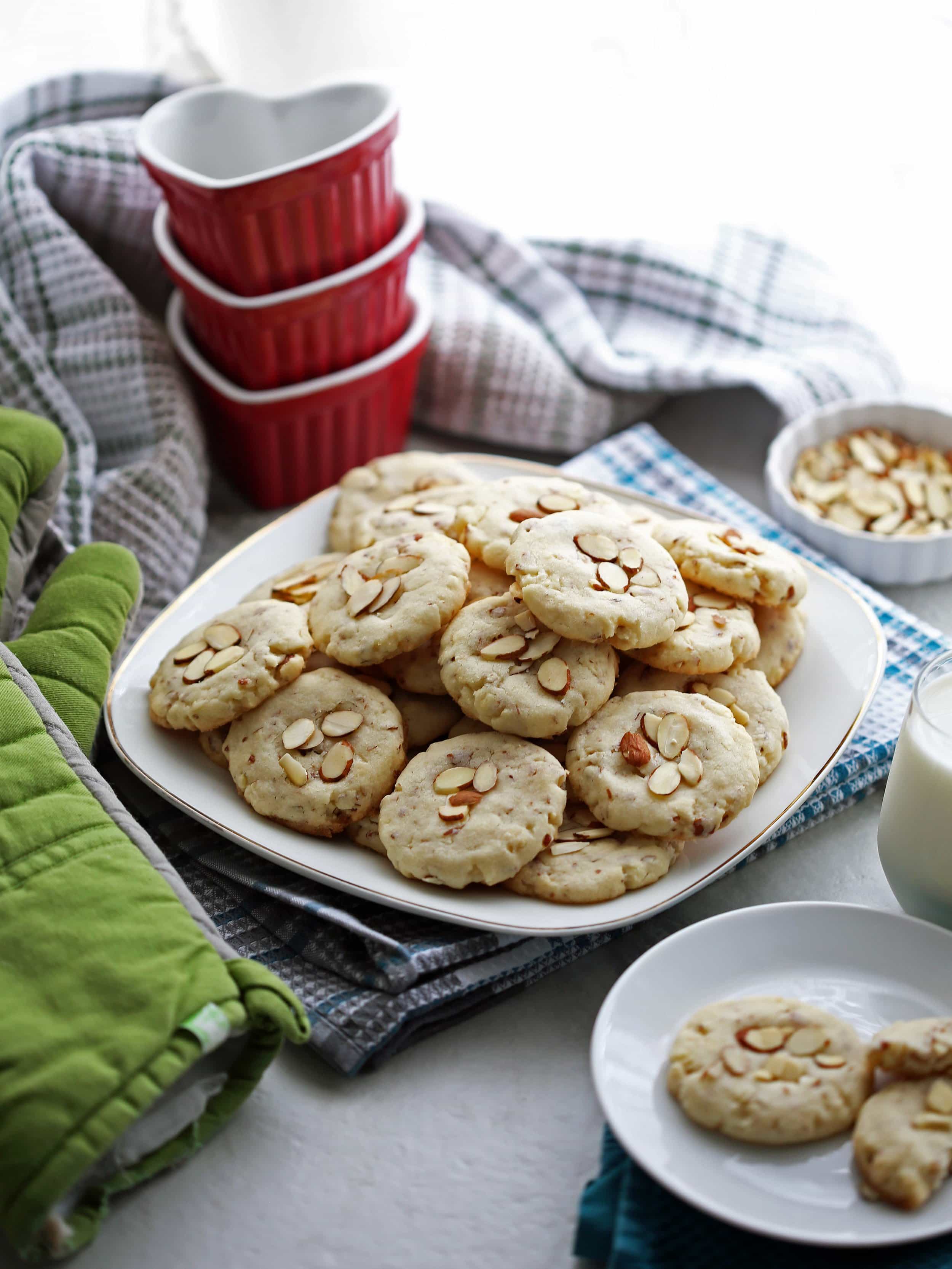 Crunchy almond cookies on a white plate.