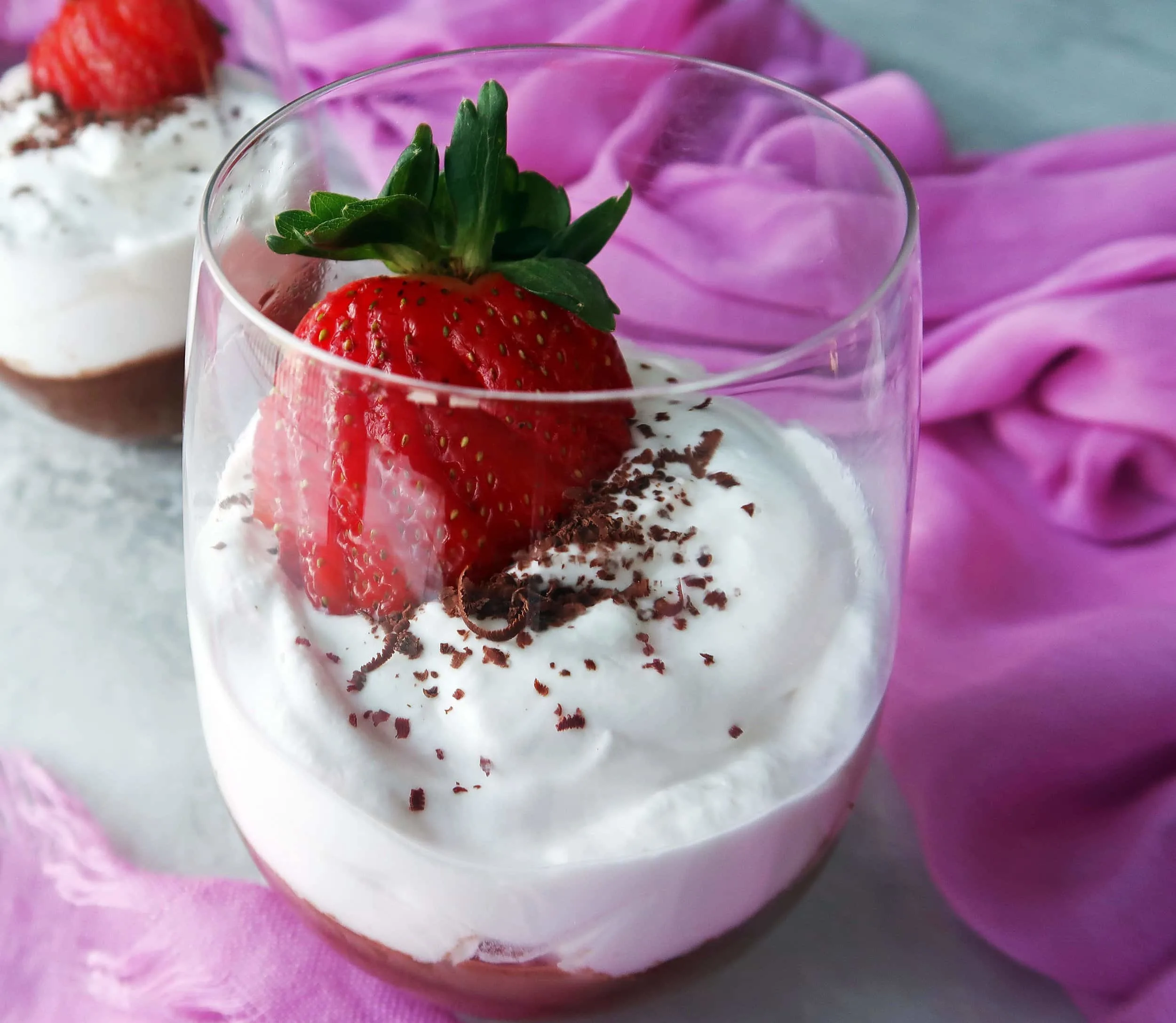 Dark Chocolate Mousse with Coconut Whipped Cream and a strawberry on top.