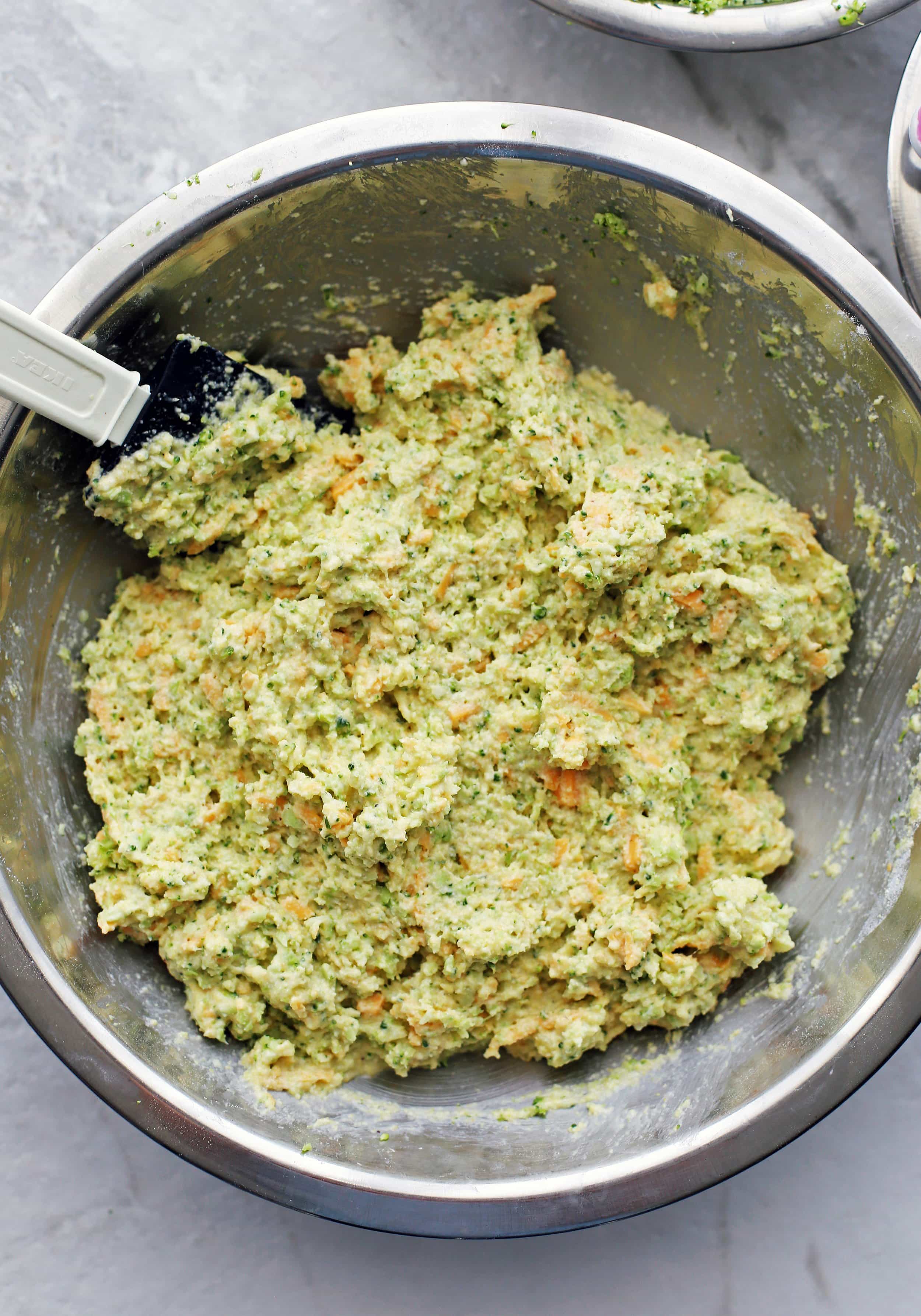 Broccoli Cheddar Cornbread Muffin batter in a large metal bowl.