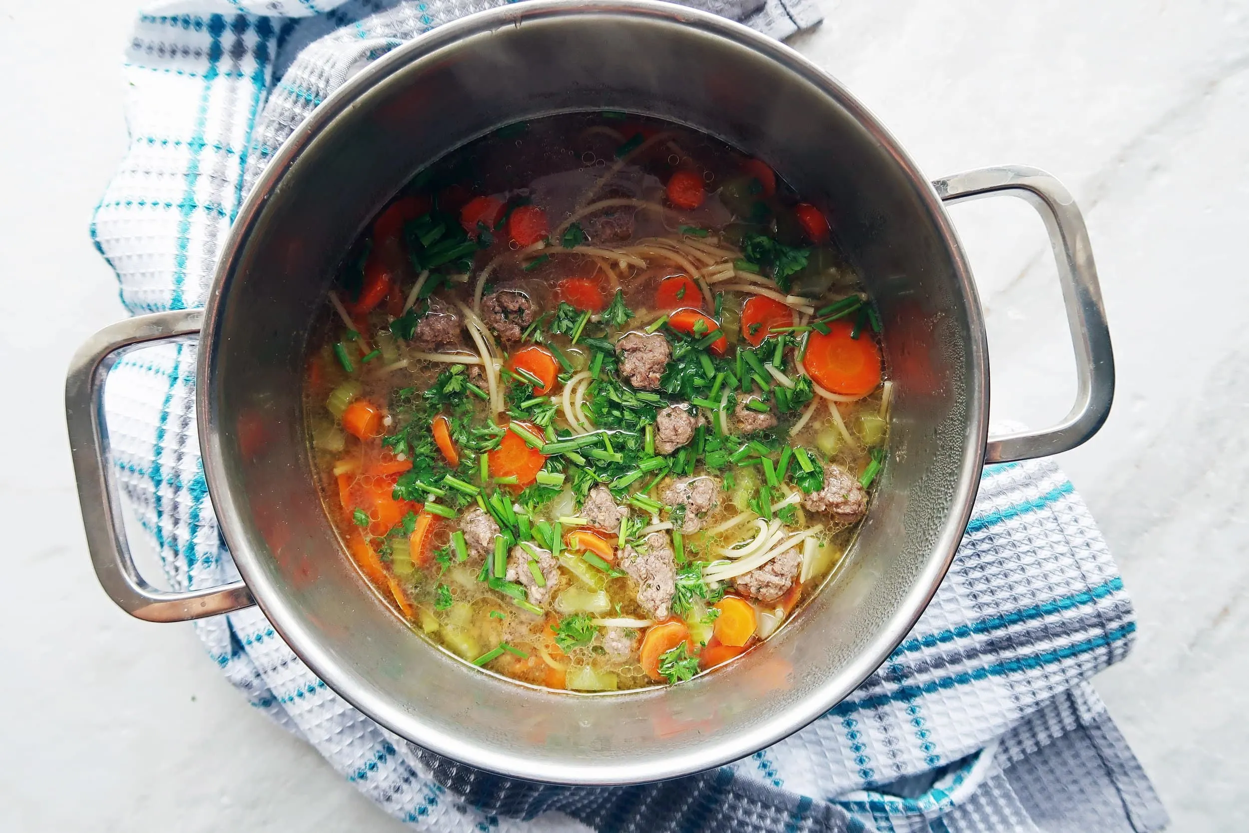 Meatball and vegetable soup in a pot.