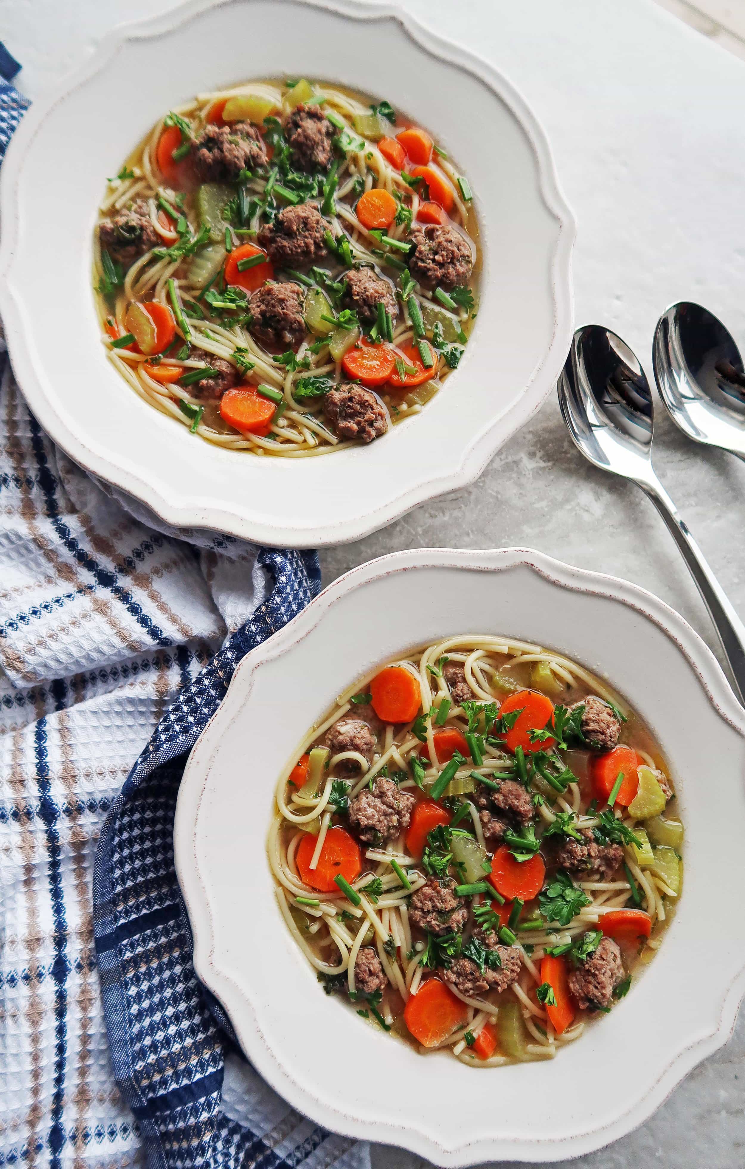 An overhead view of two bowls of Dutch Vegetable Soup with Meatballs