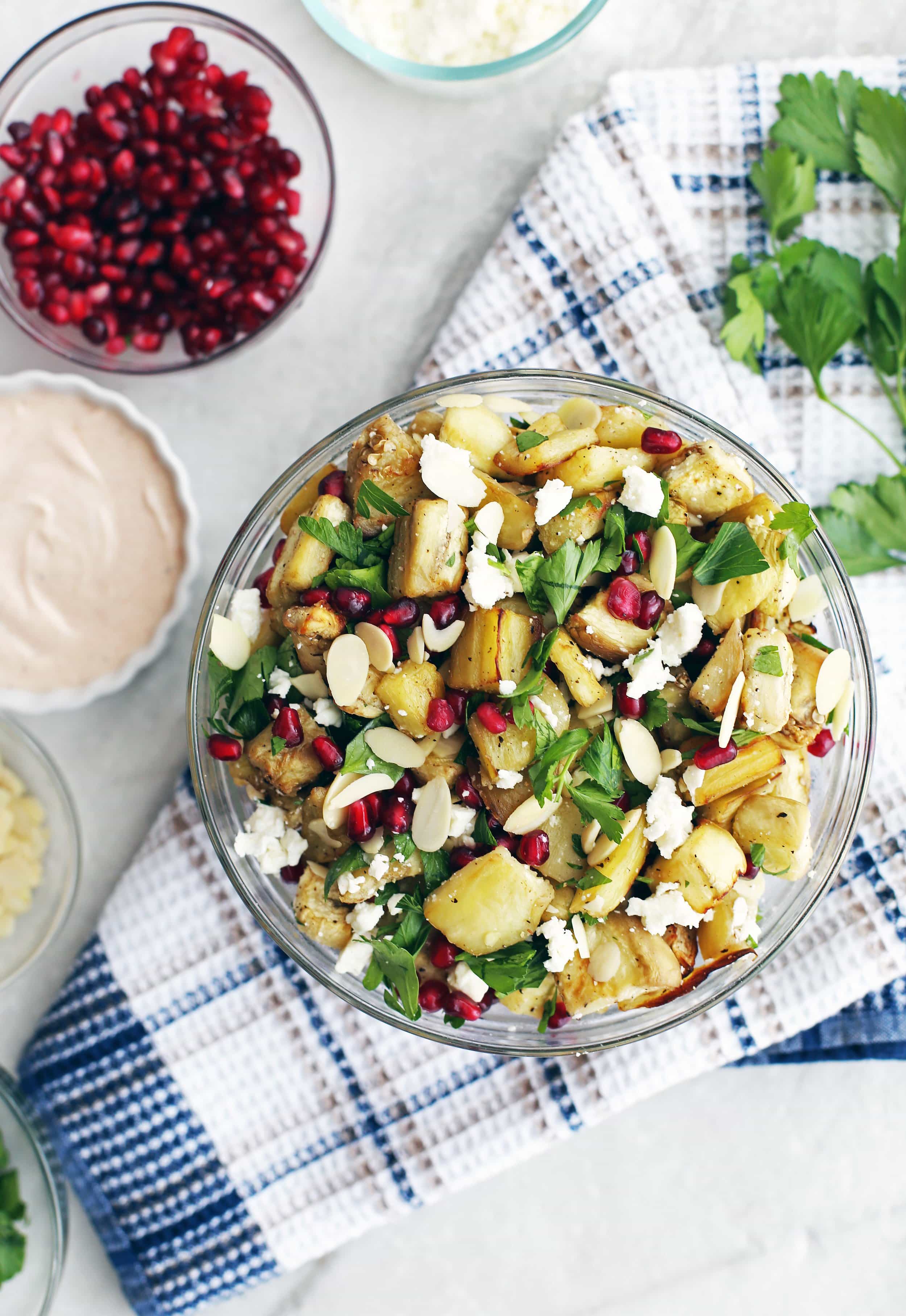 Overhead view of roasted eggplant pomegranate feta salad in a glass bowl.