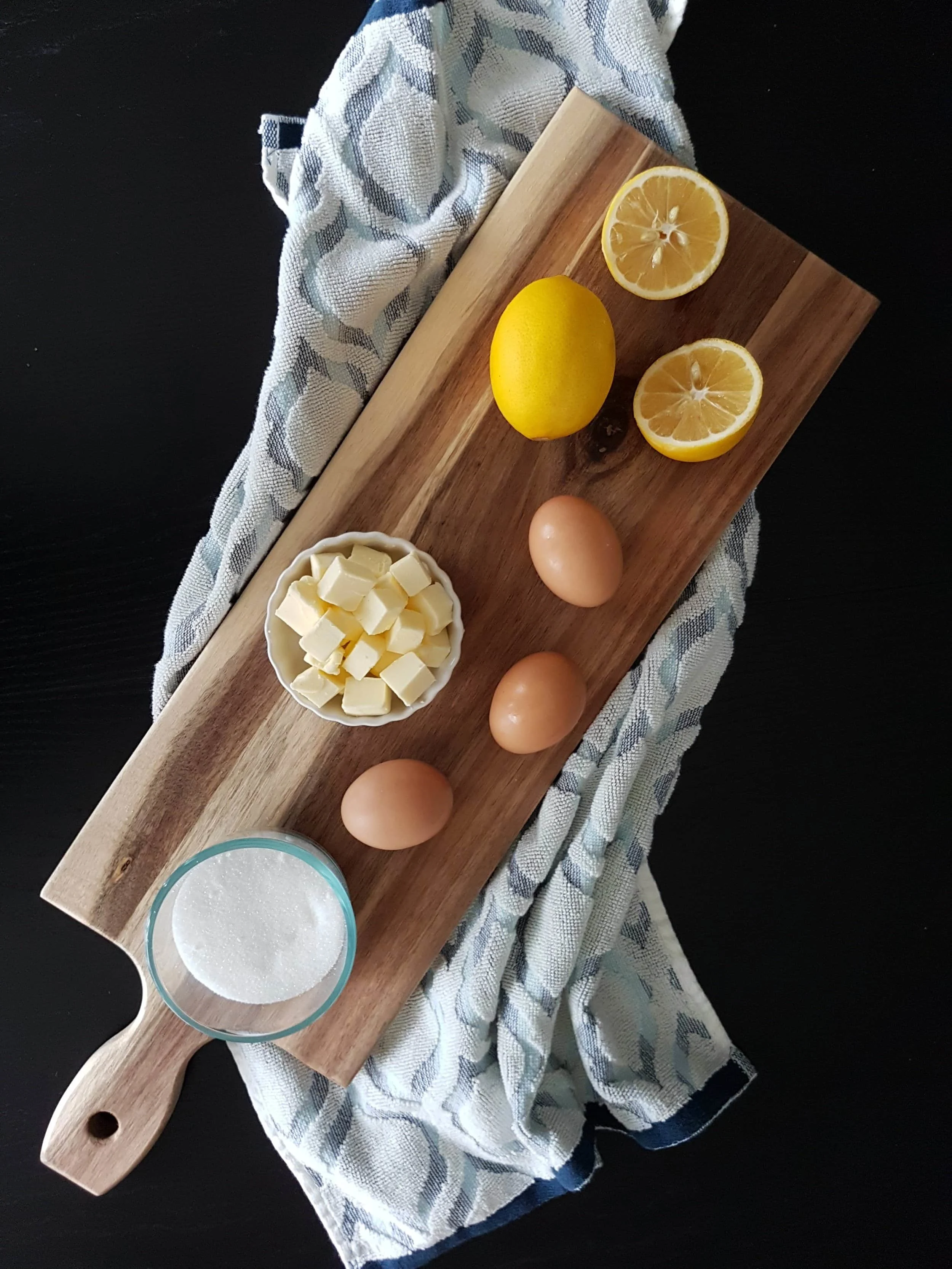 Eggs, butter, sugar, and lemons, ready to be combined into lemon curd.