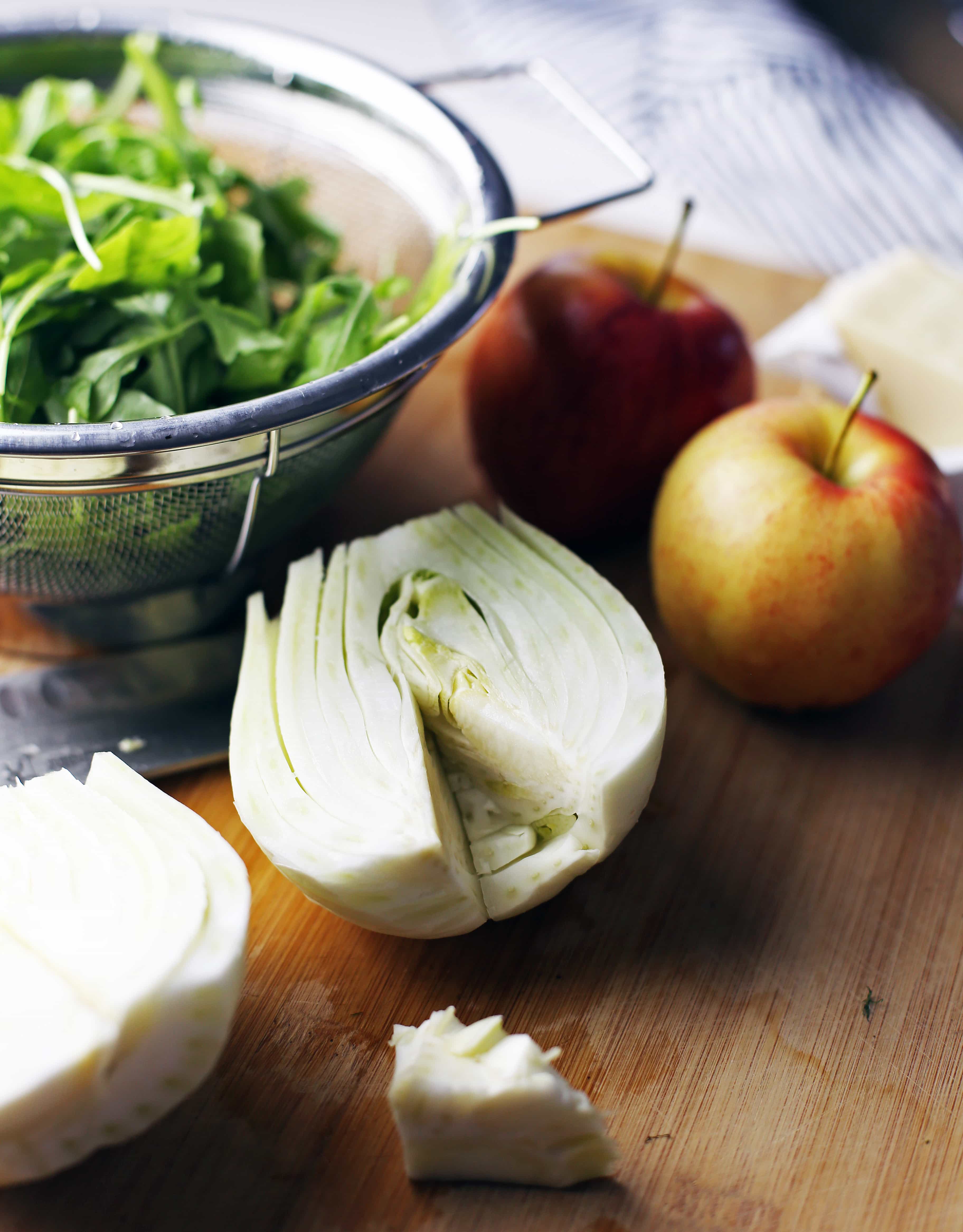 Apples, arugula, and a fennel bulb with the core removed.