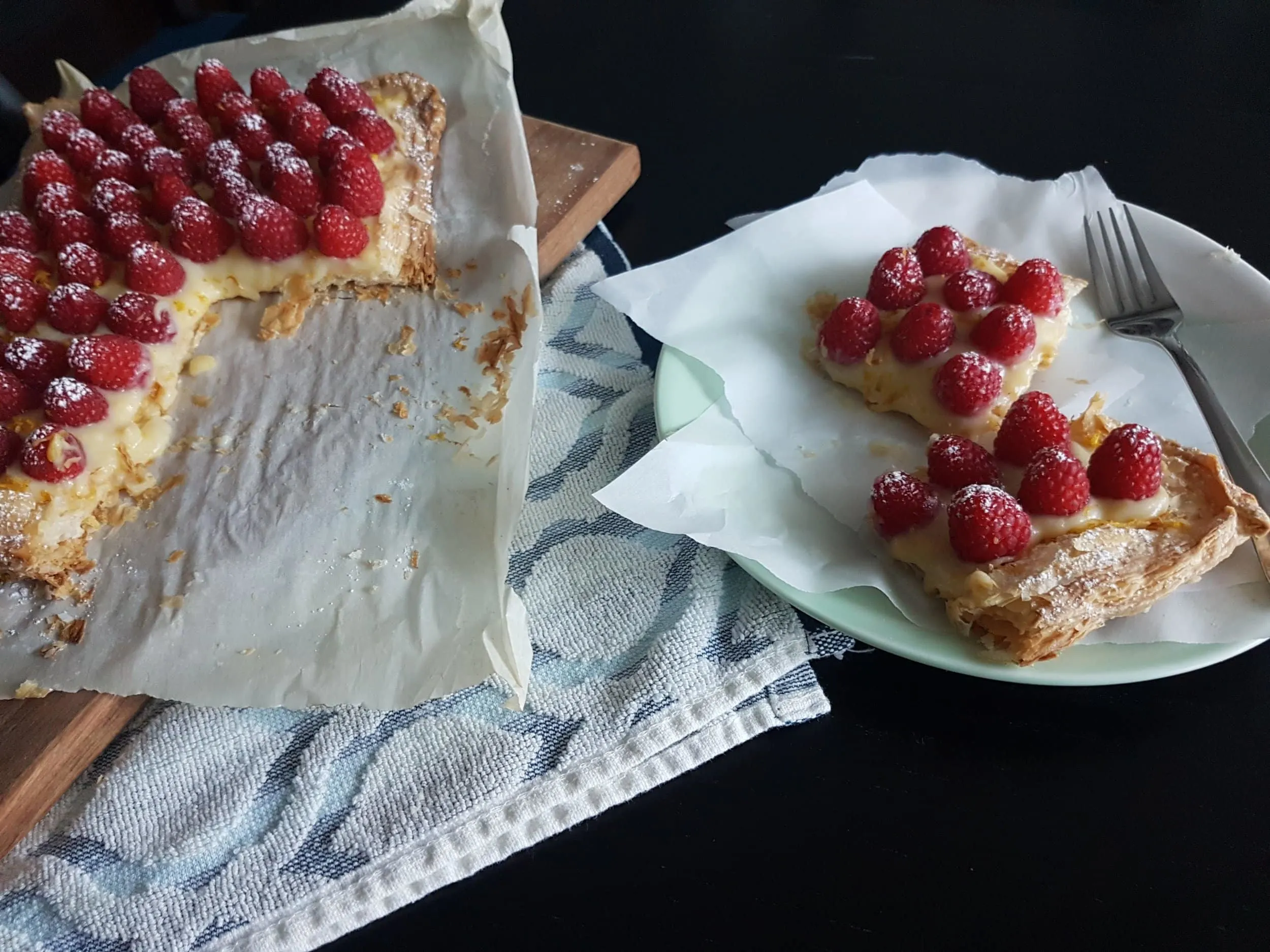 Two pieces of Fresh Raspberry Lemon Curd Tart on a plate.