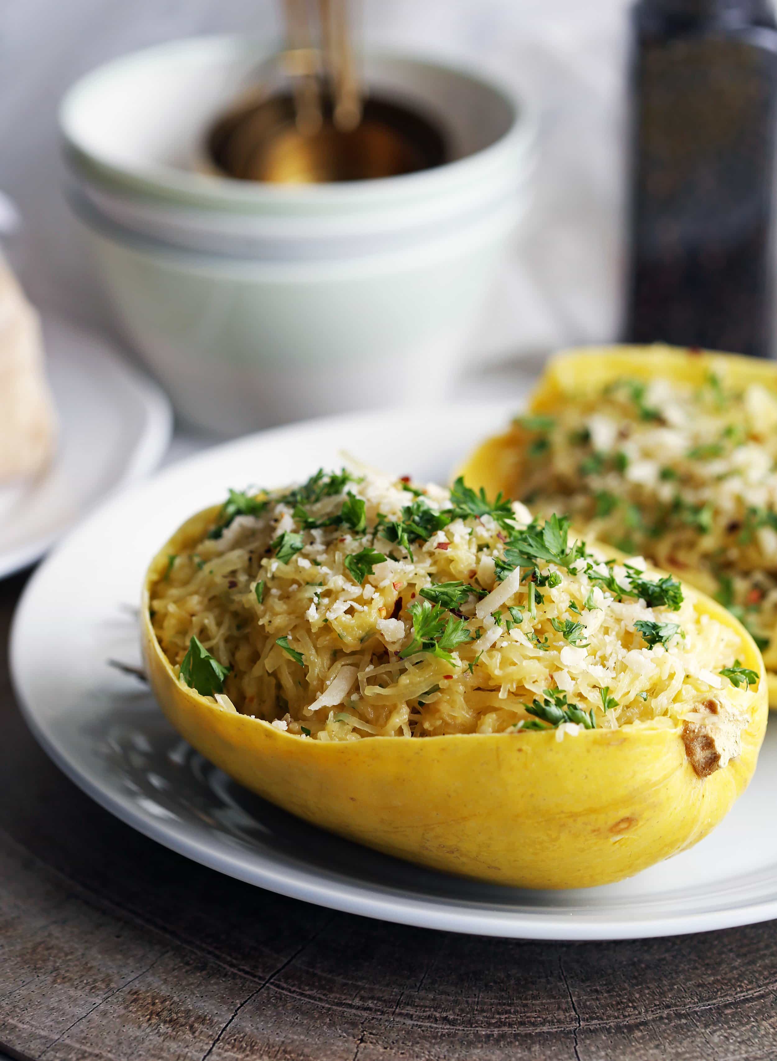 Instant Pot Garlic Parmesan Spaghetti Squash placed in a halved hollowed spaghetti squash shell (skin).