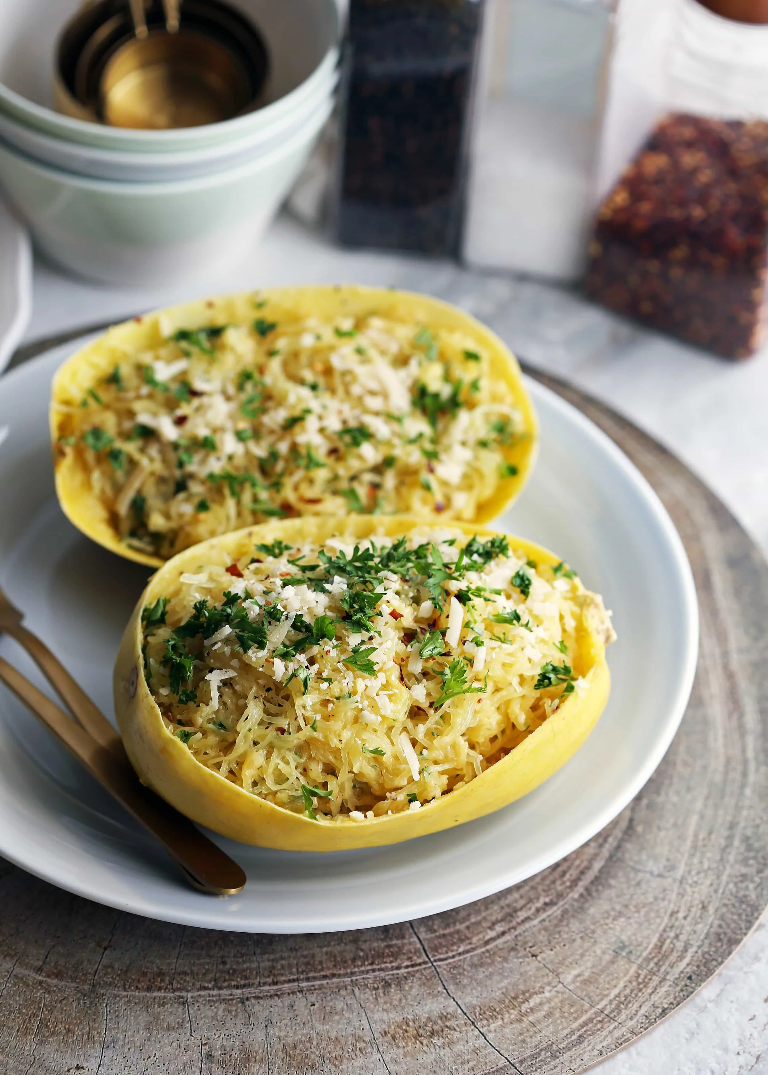 Instant Pot Garlic Parmesan Spaghetti Squash placed in two halved hollowed spaghetti squash shells (skin).