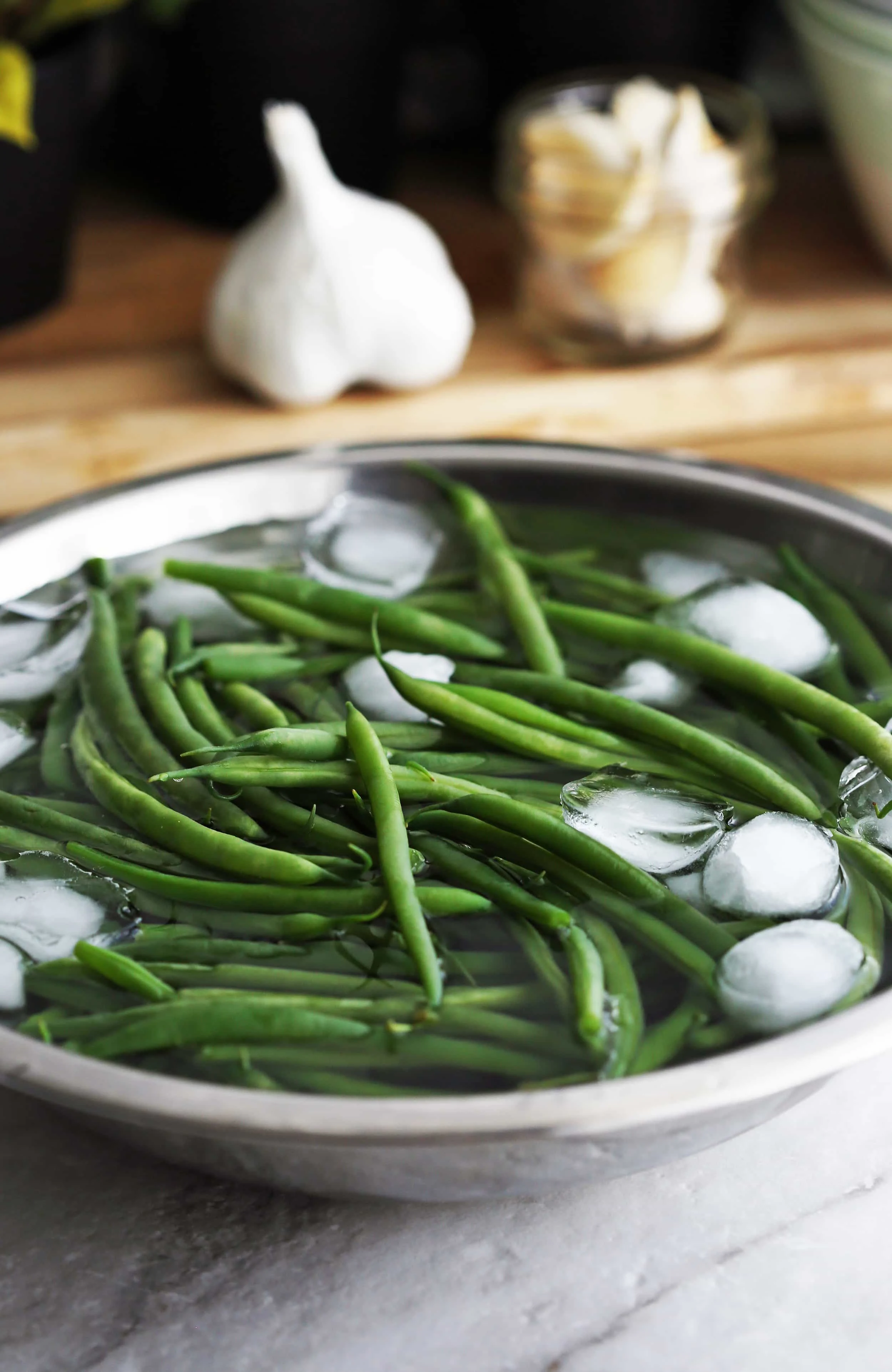 Blanched French green beans in an ice bath.